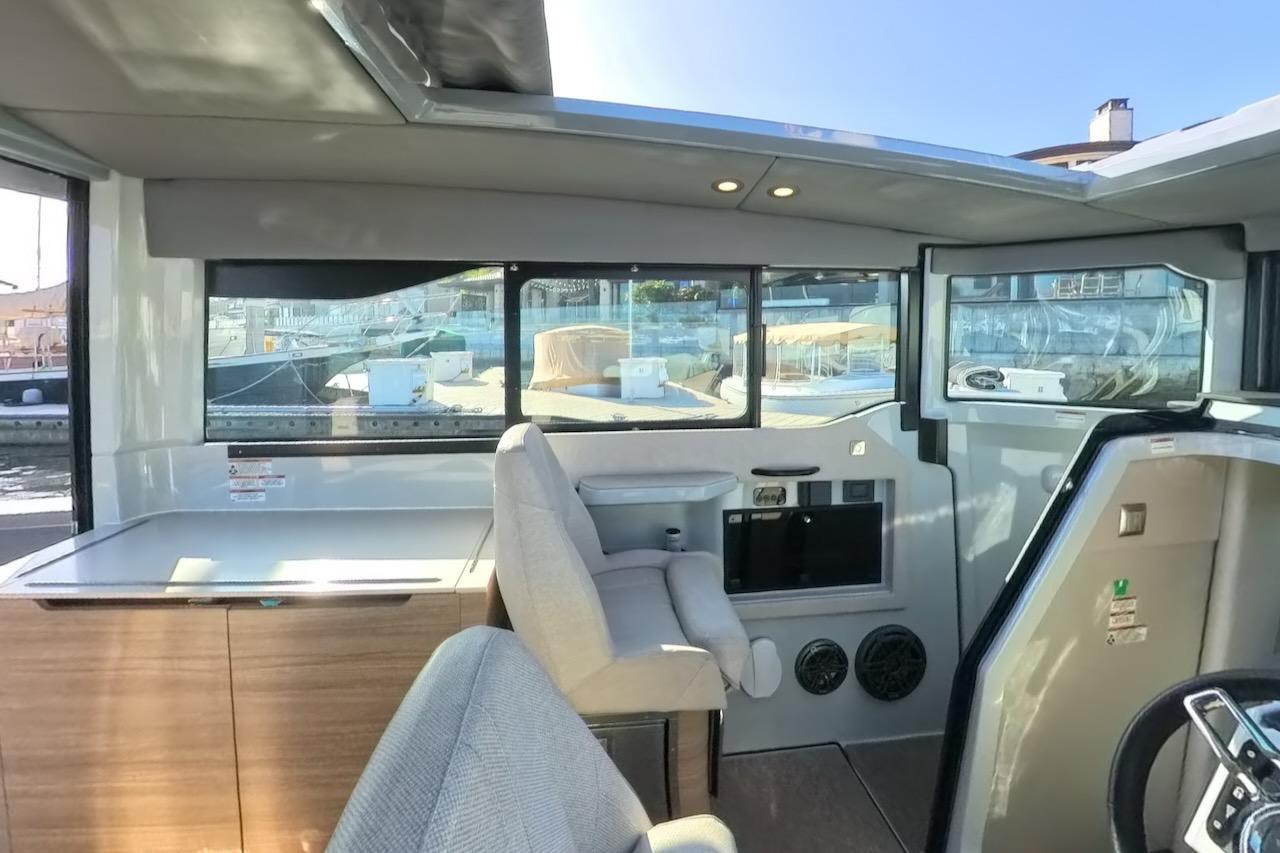 Interior of 2024 Saxdor 320 GTC boat, featuring modern seating and large windows.