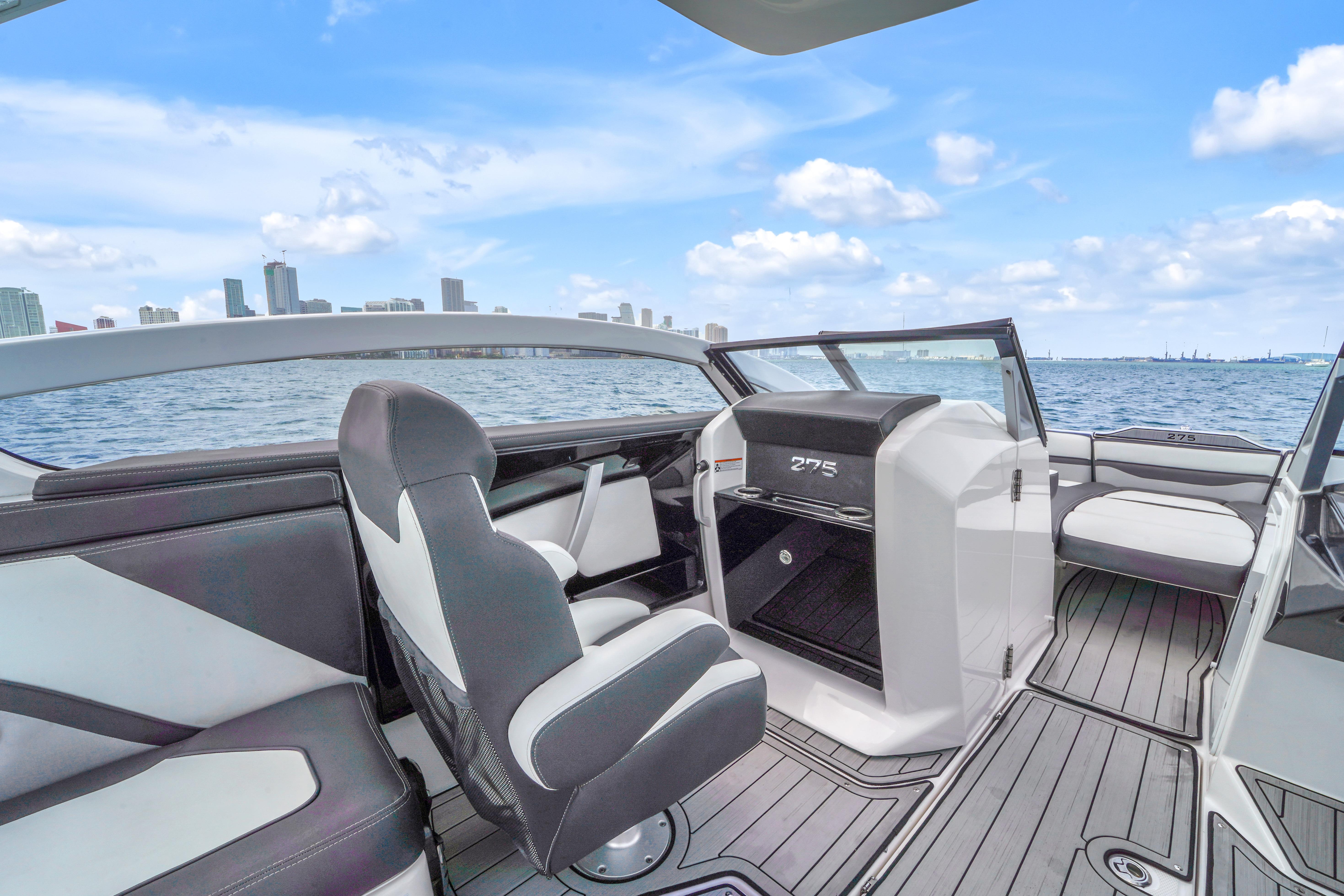 Interior of 2021 Yamaha Boats 275SD, featuring sleek seating and modern dashboard on open water.