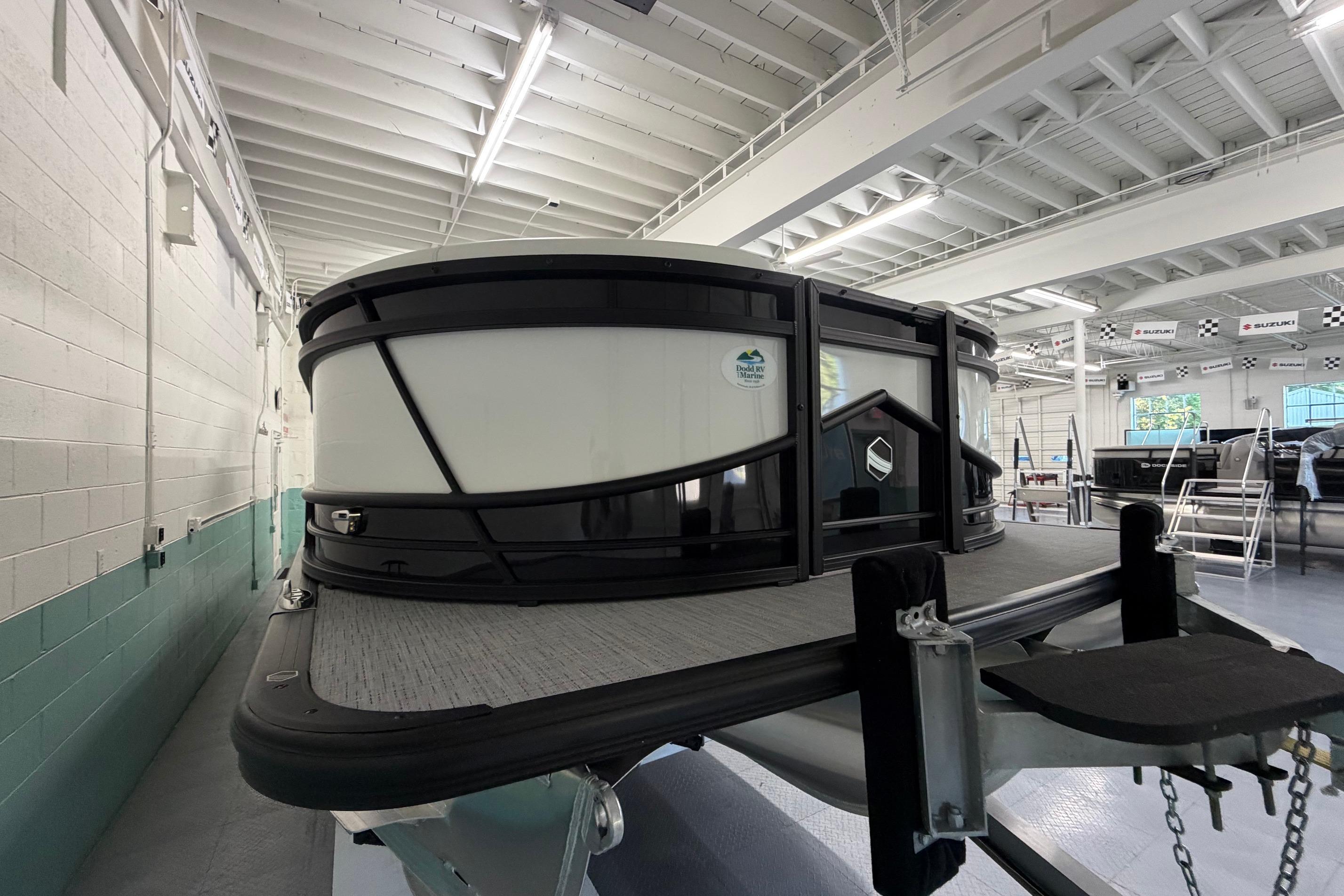 2026 South Bay 525SB2 pontoon boat in a showroom, showcasing sleek design and modern features.
