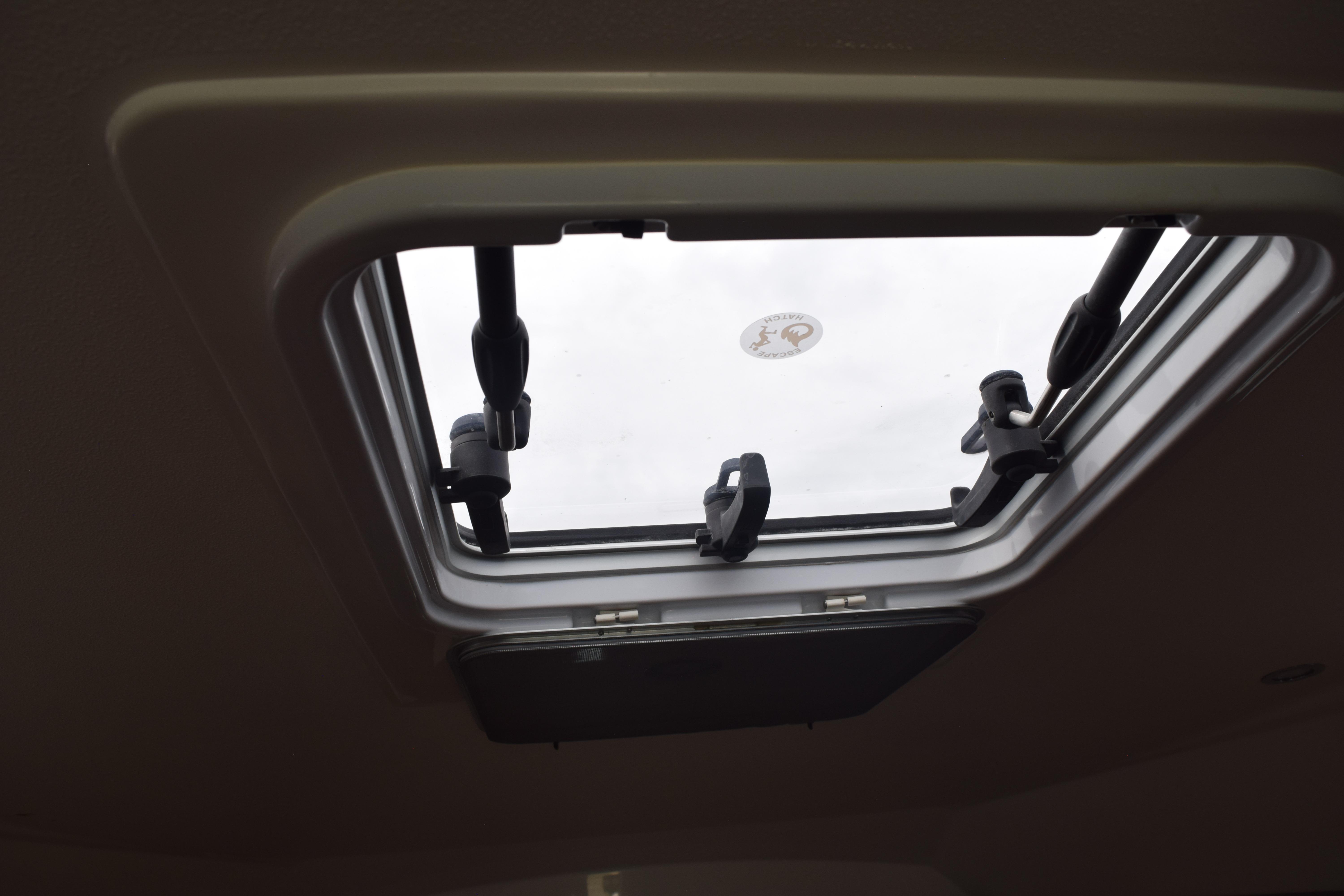 Open hatch on 2022 Pursuit OS 355 Offshore boat, viewed from interior.