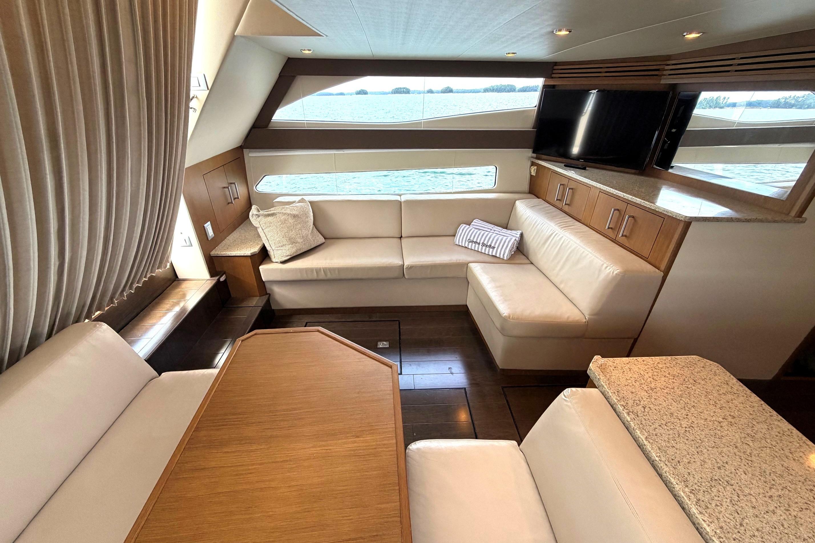 Luxurious interior of 2011 Carver 44 Sojourn yacht with elegant seating and modern decor.
