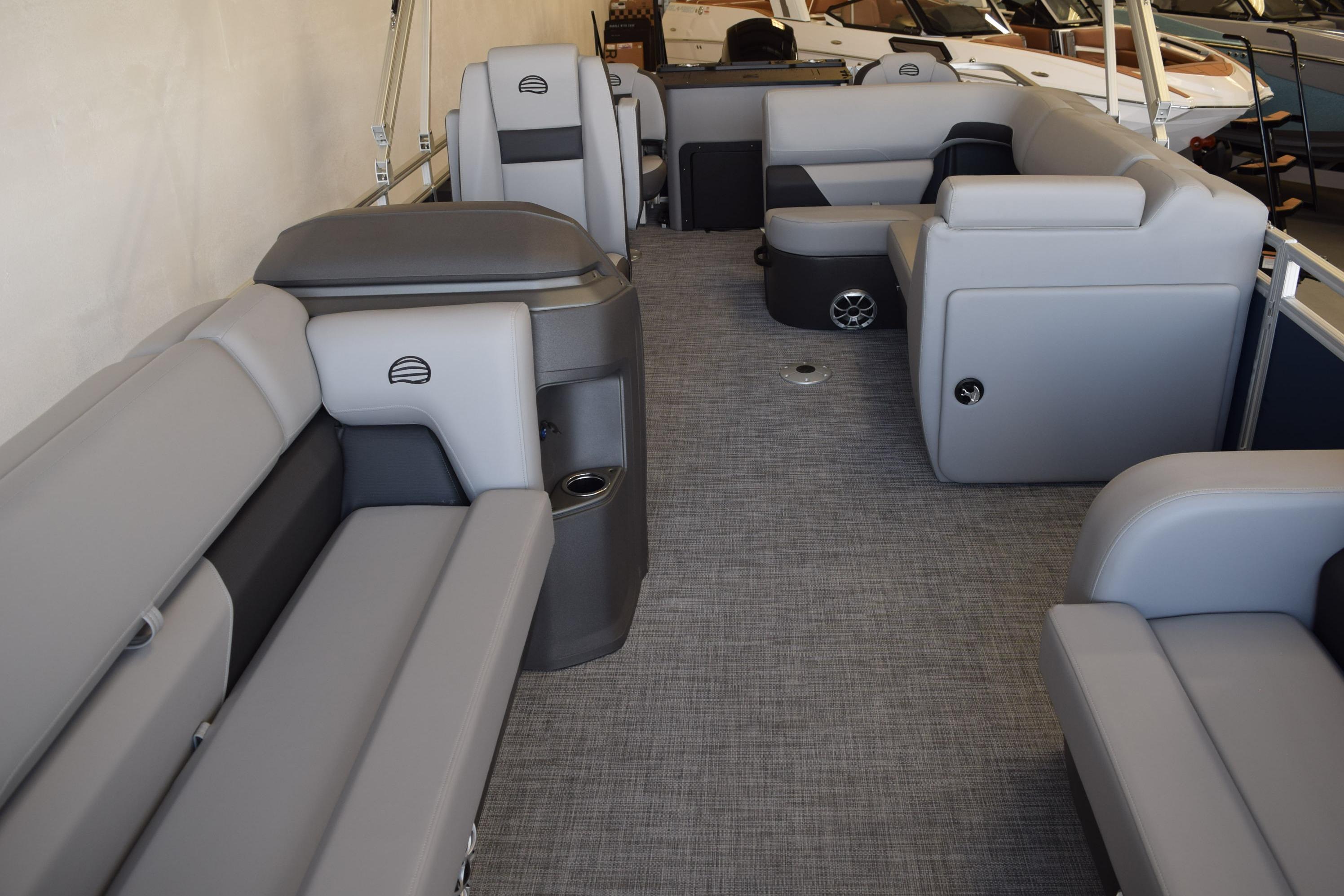 2026 Sun Tracker SportFish 22 DLX interior with gray seating and spacious layout.