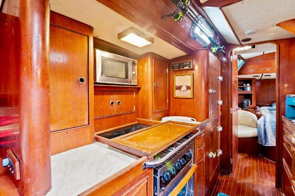 Interior of 1989 Concordia 52 yacht with wooden cabinetry and modern kitchen amenities.