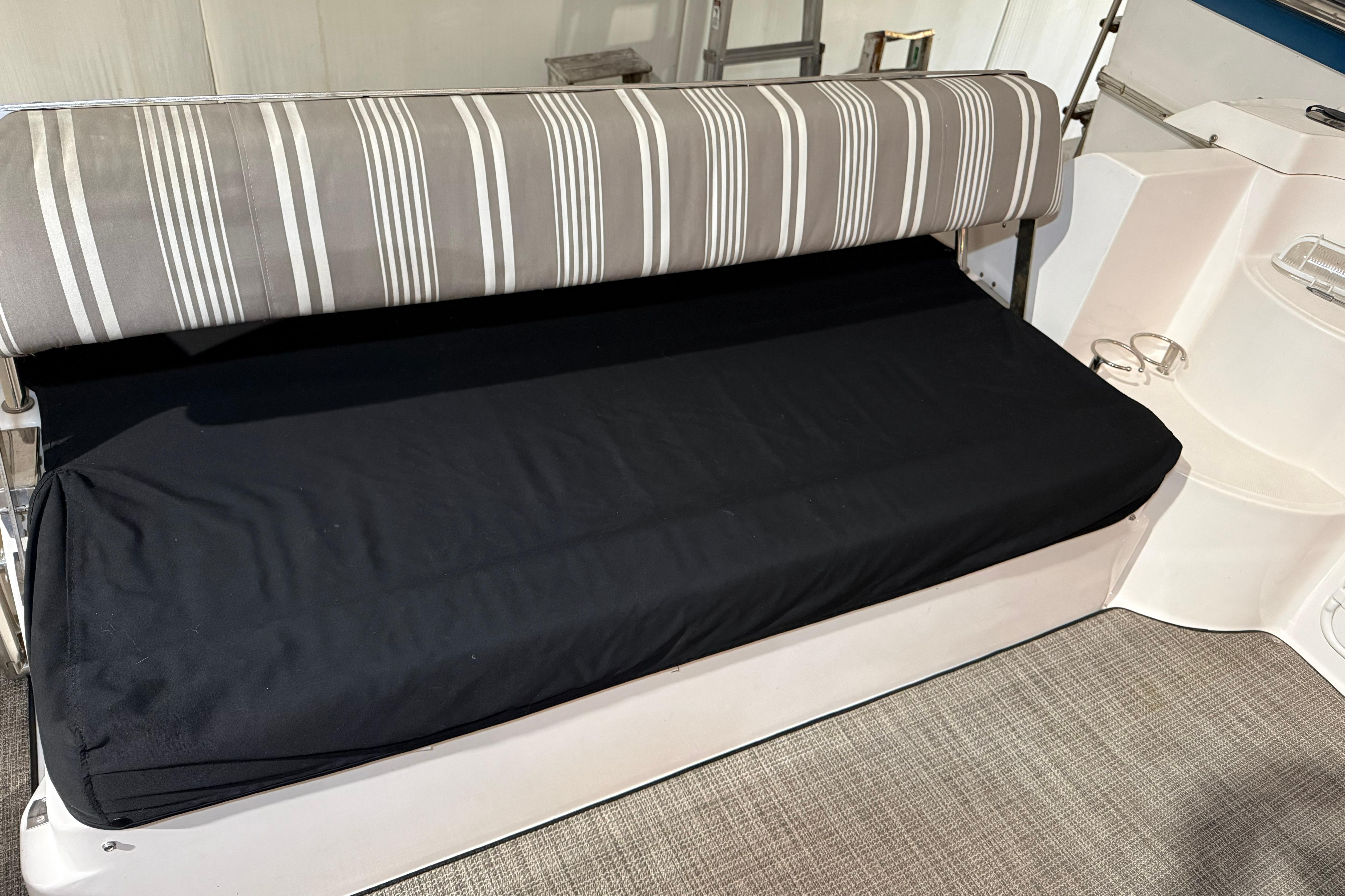 2007 Regal Commodore 3760 IO boat interior with striped seating and black cushion.