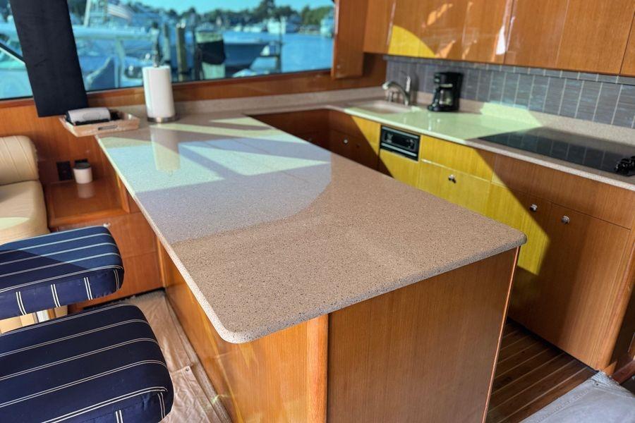 Luxurious kitchen interior of 2002 Viking 61 Enclosed Bridge yacht with modern amenities.