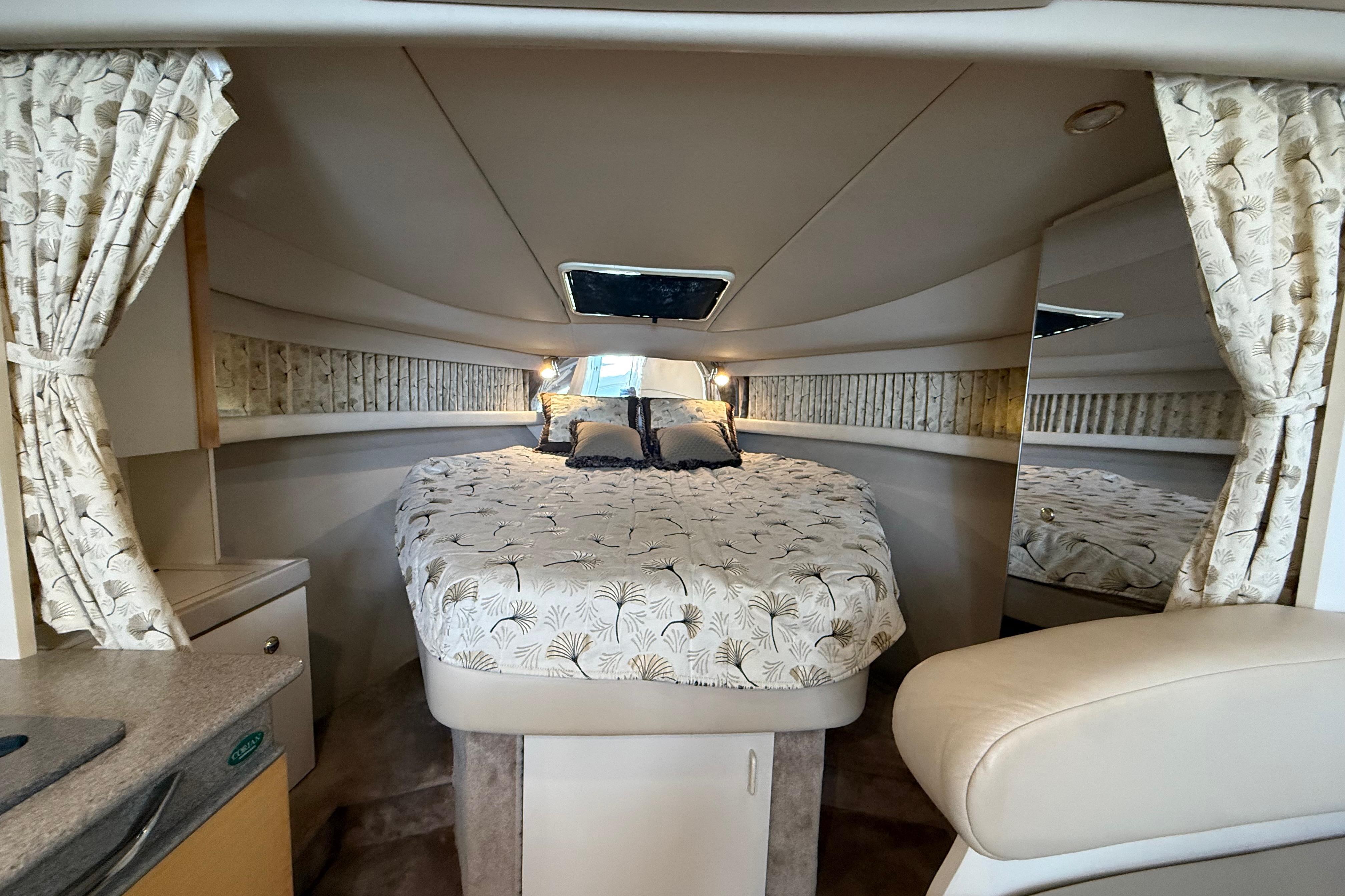 Interior of 1999 Formula 34 Performance Cruiser with cozy bed and elegant decor.