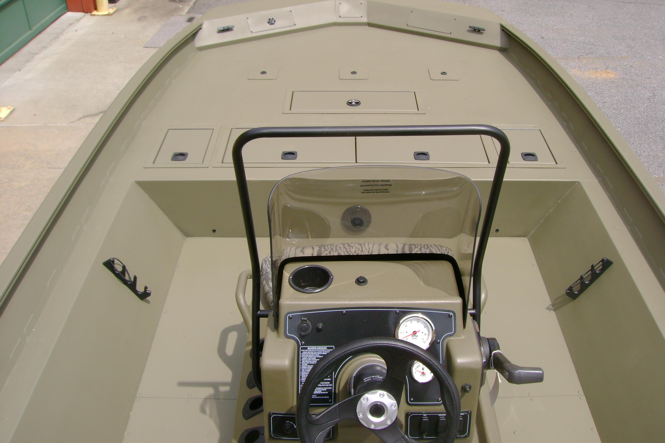 2026 Tracker Grizzly 2072 CC boat interior with steering console and storage compartments.