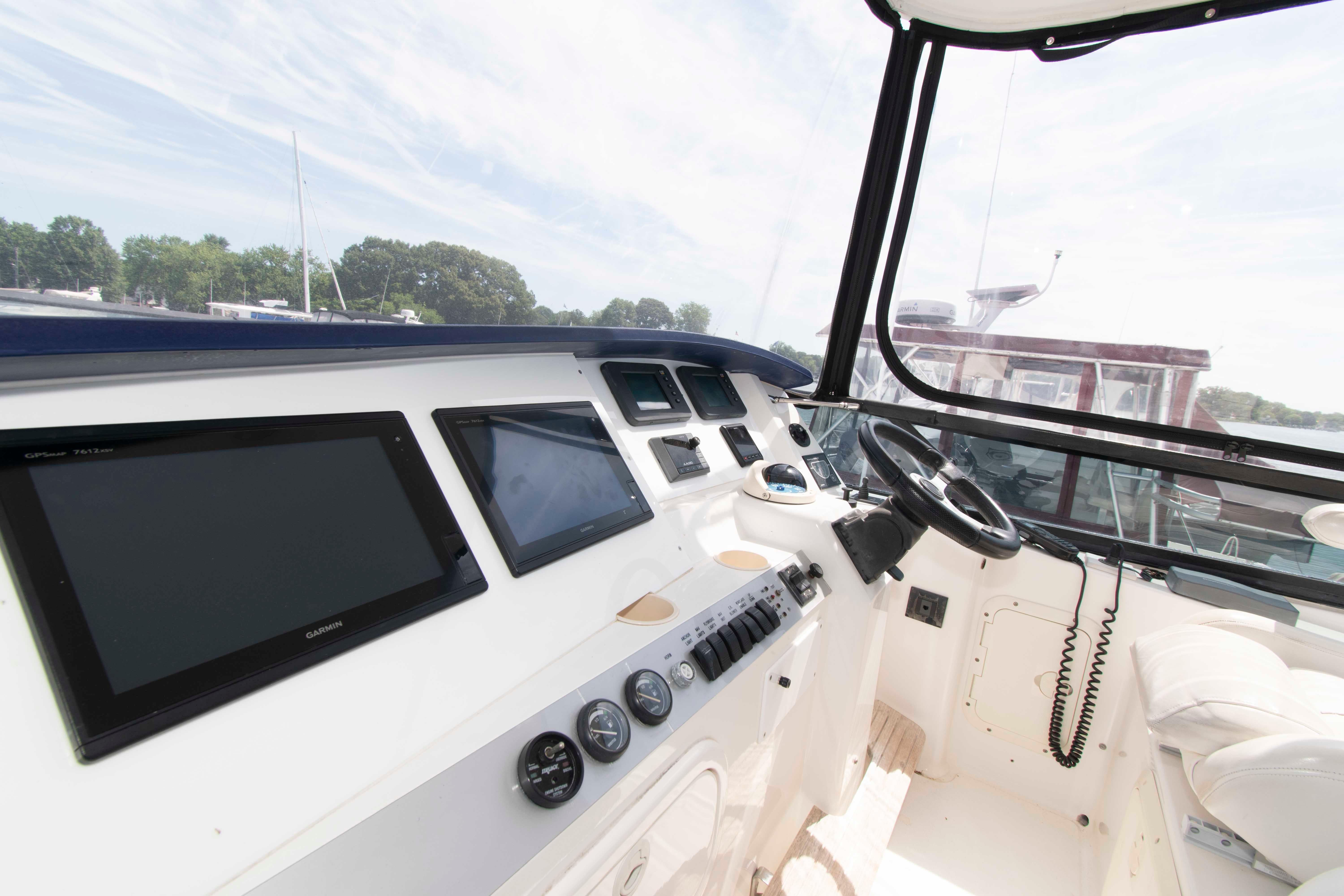 Interior view of 2003 Neptunus 56 Flybridge yacht cockpit with navigation equipment.