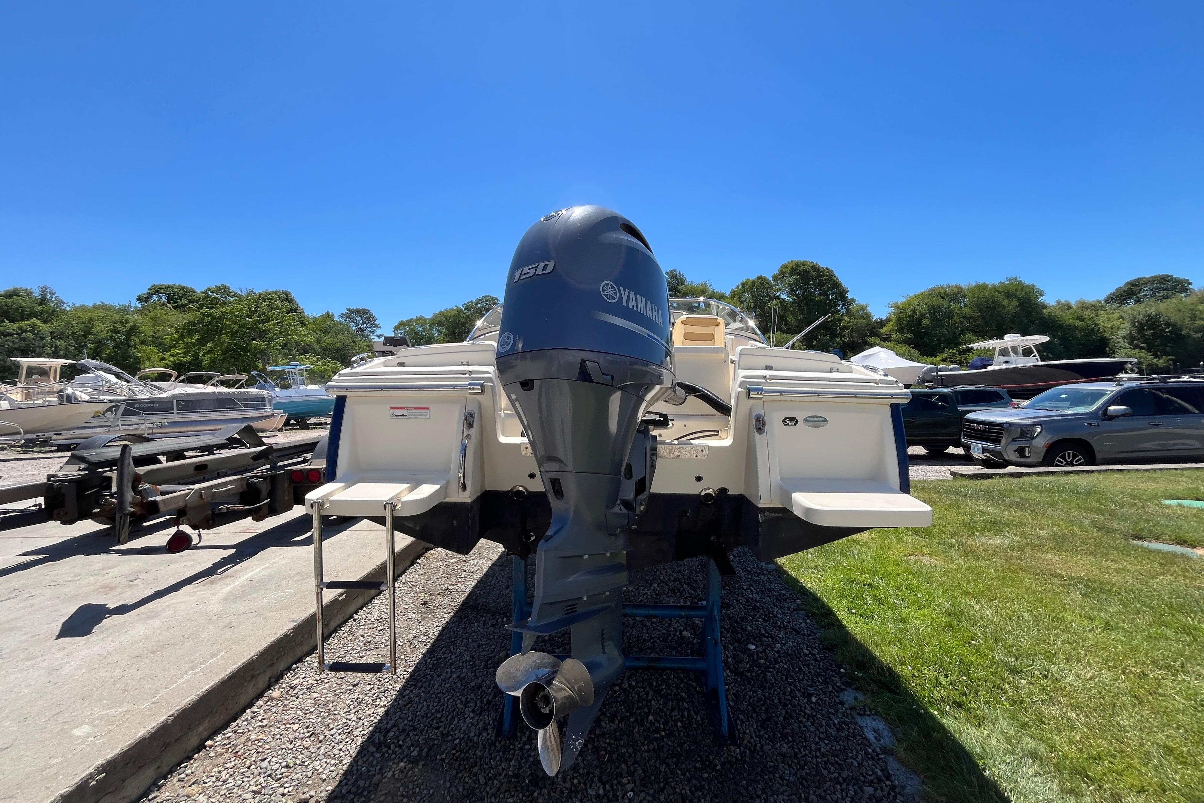 2017 Scout 210 Dorado boat with Yamaha 150 engine, parked outdoors on a sunny day.