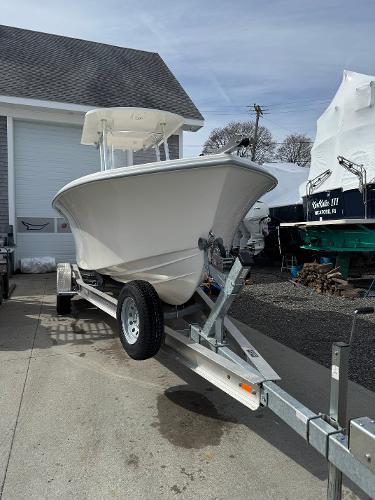 2025 NorthCoast 230 Center Console boat on trailer, parked outdoors near a garage.