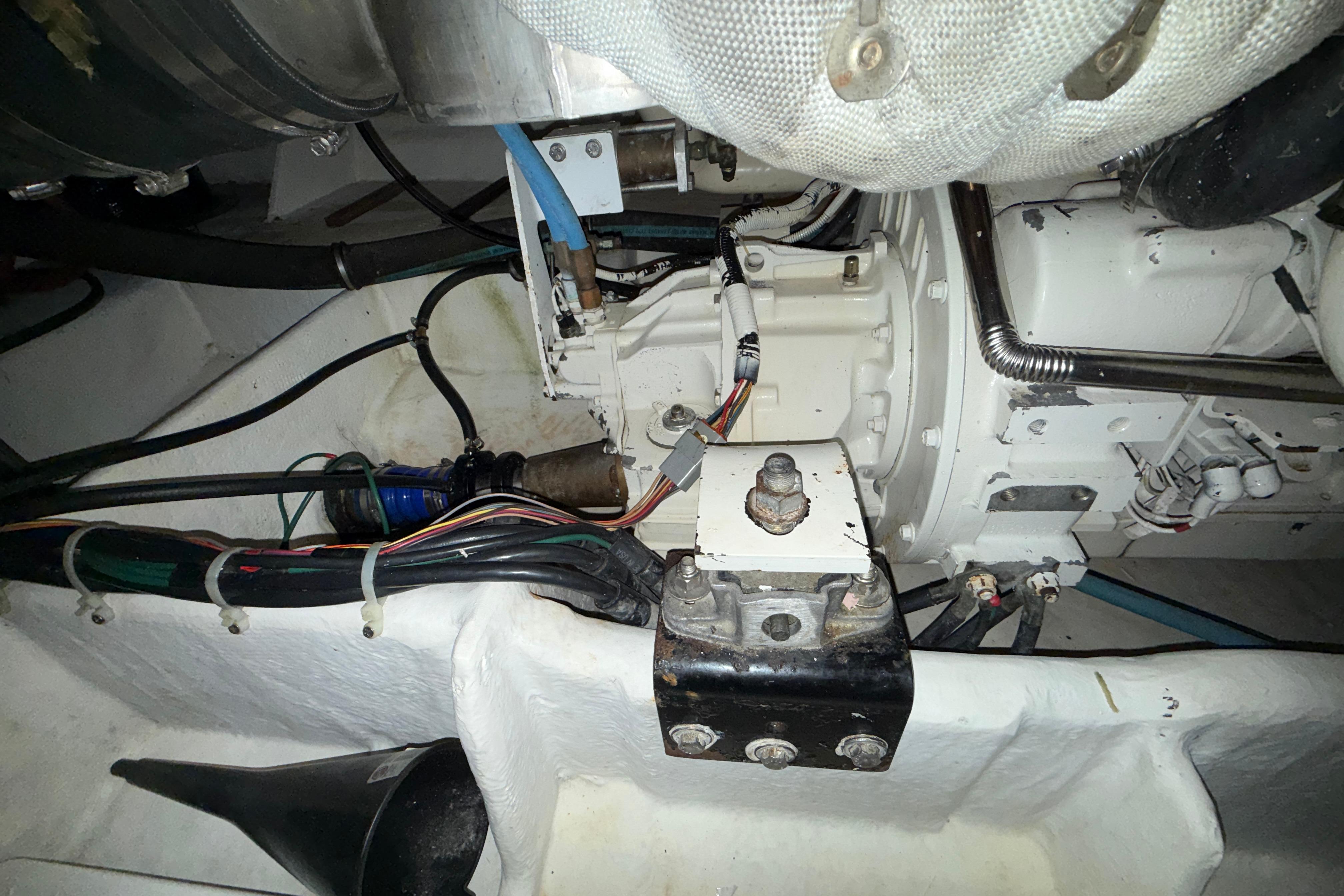 Engine room of 1998 Bayliner 4788 Pilot House Motoryacht, showcasing mechanical components and wiring.