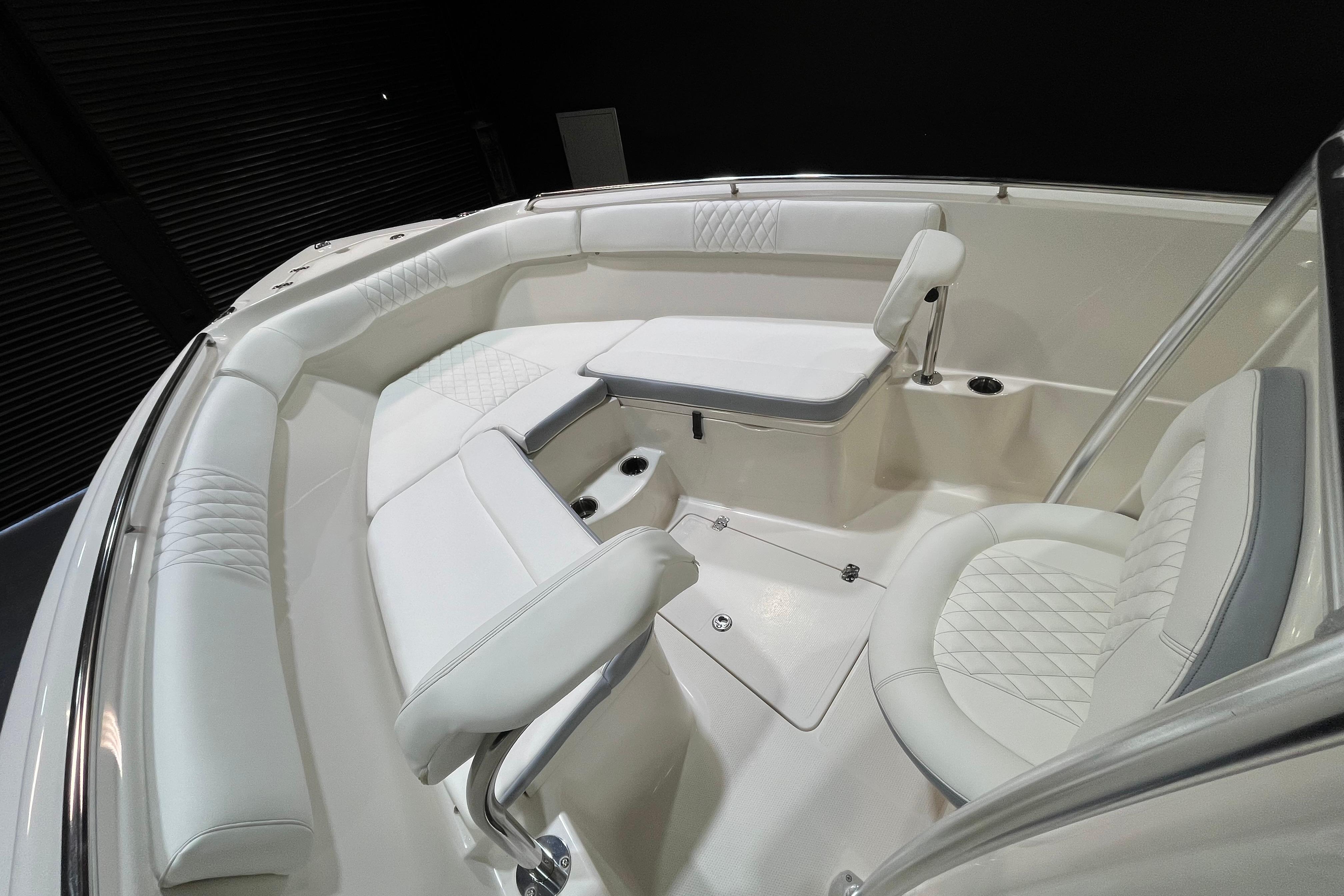 2022 Sailfish 242 CC boat interior with white cushioned seating and sleek design.