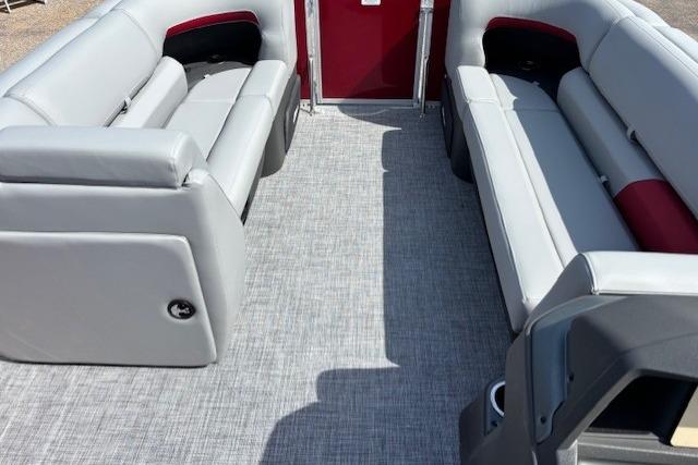 2026 Sun Tracker Party Barge 20 DLX interior with gray seating and red accents.