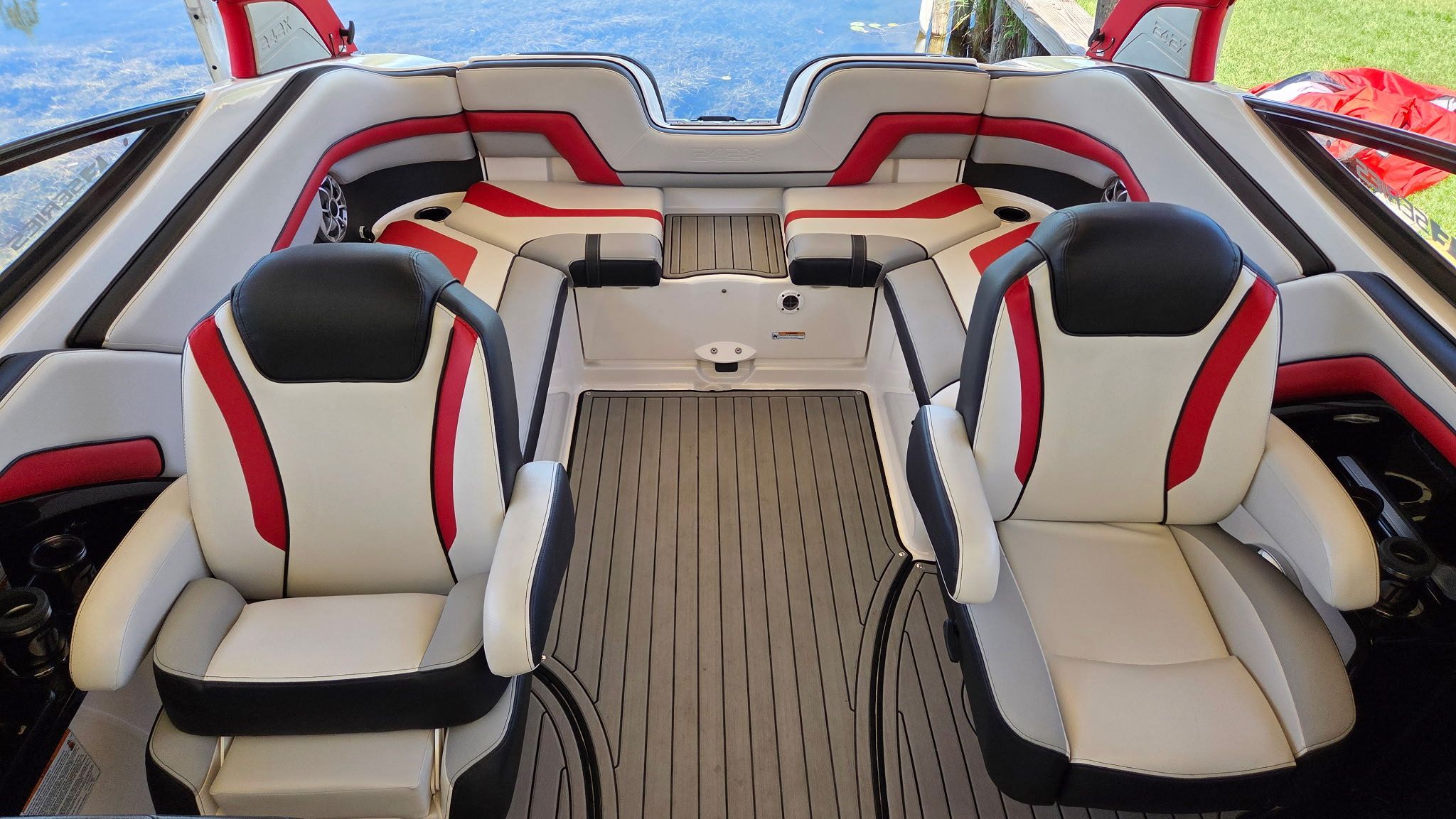 The image shows the interior of a 2018 Yamaha 242X E-Series boat with stylish seating.