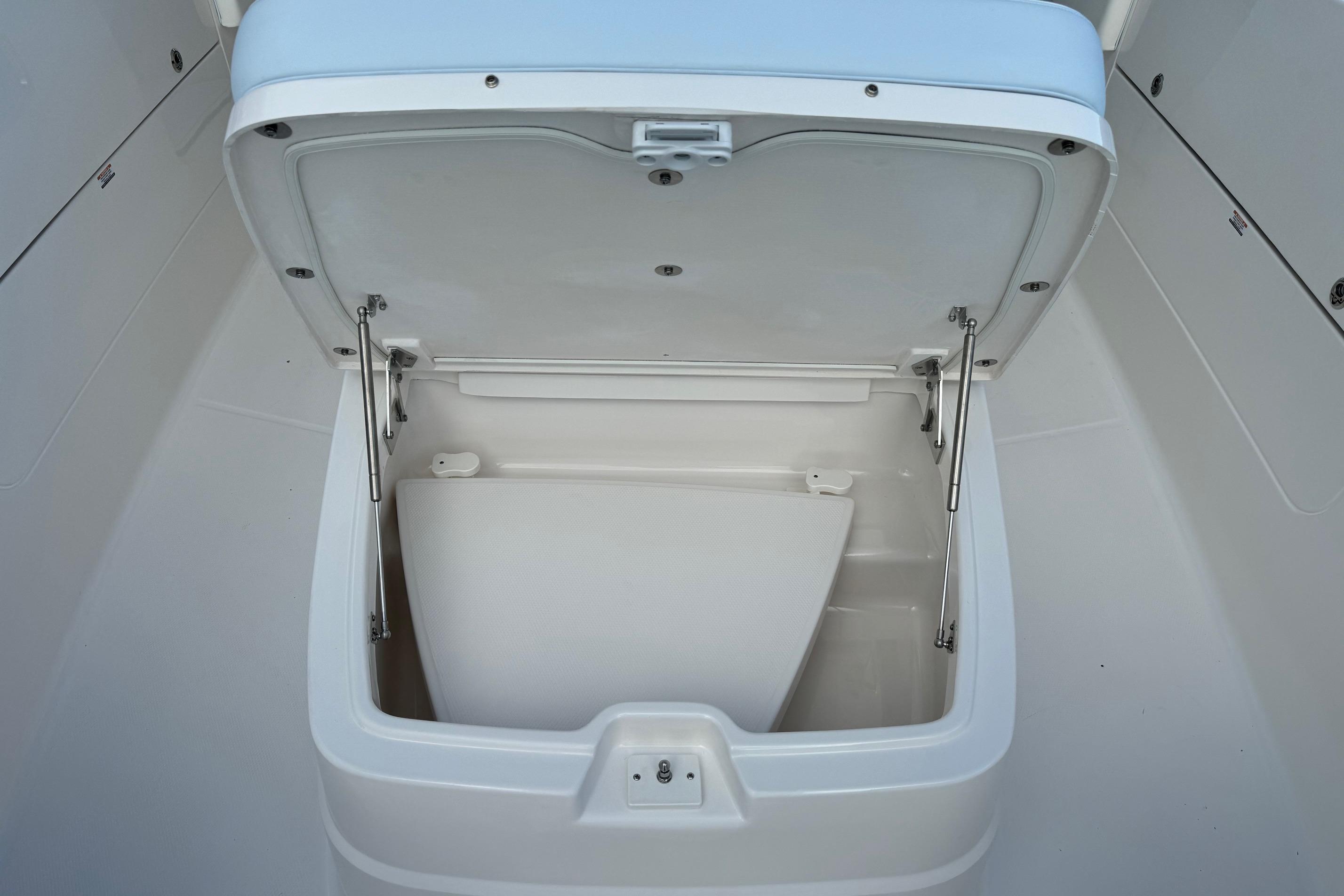 2025 Robalo R360 Center Console storage compartment with open lid, showcasing interior space.
