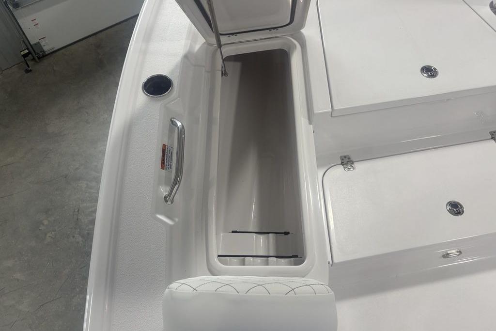 2026 Sportsman Masters 227 boat interior storage compartment with open hatch.