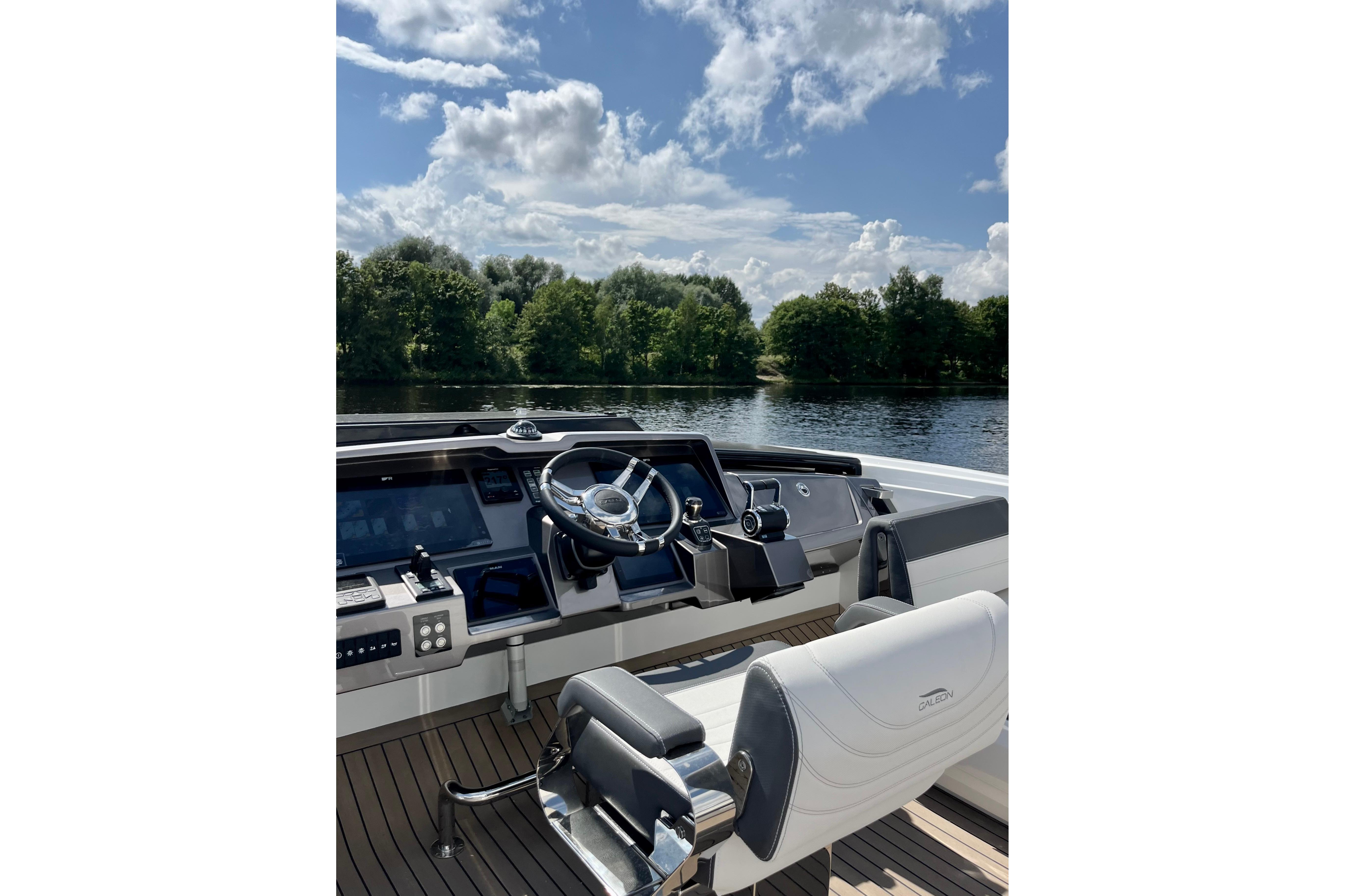 Cockpit of 2025 Galeon 700 Sky yacht with scenic water view.