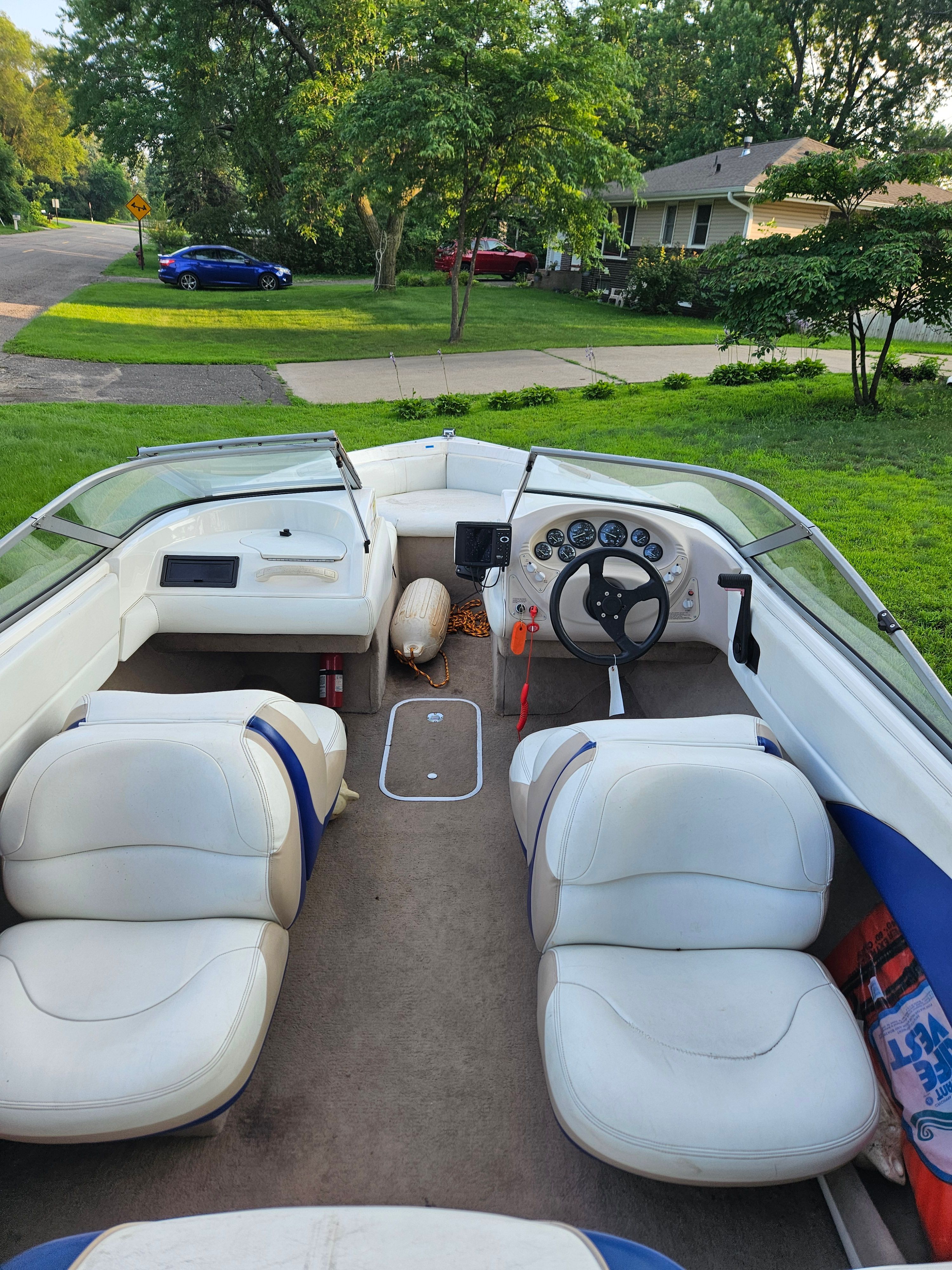 Interior view of a 1996 Wellcraft Excel boat with white seats and dashboard.