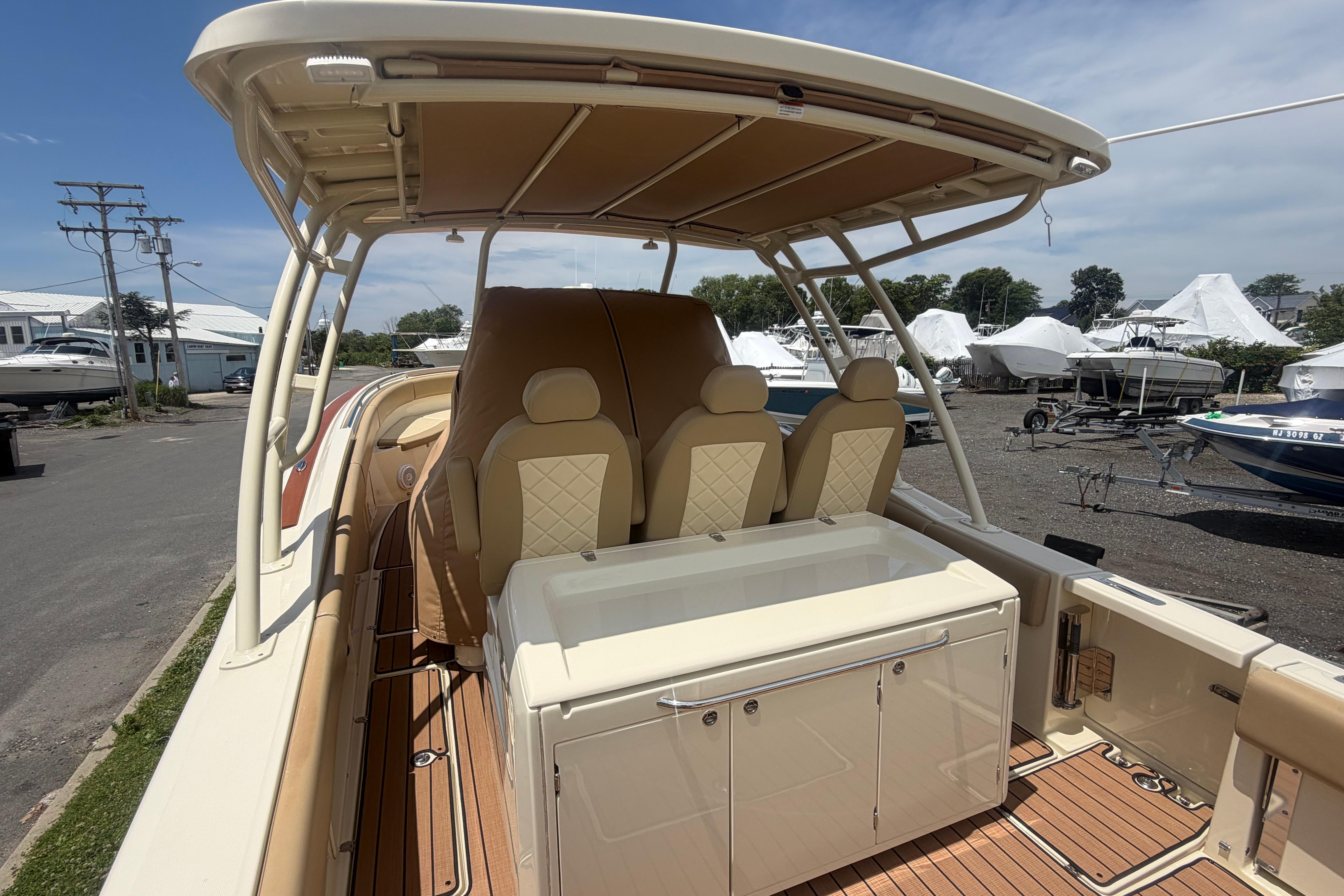 2017 Chris-Craft Catalina 34 boat interior with seating and storage, docked outdoors.