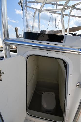 2021 Eastern 248 Center Console boat with an open cabin door showing the interior.