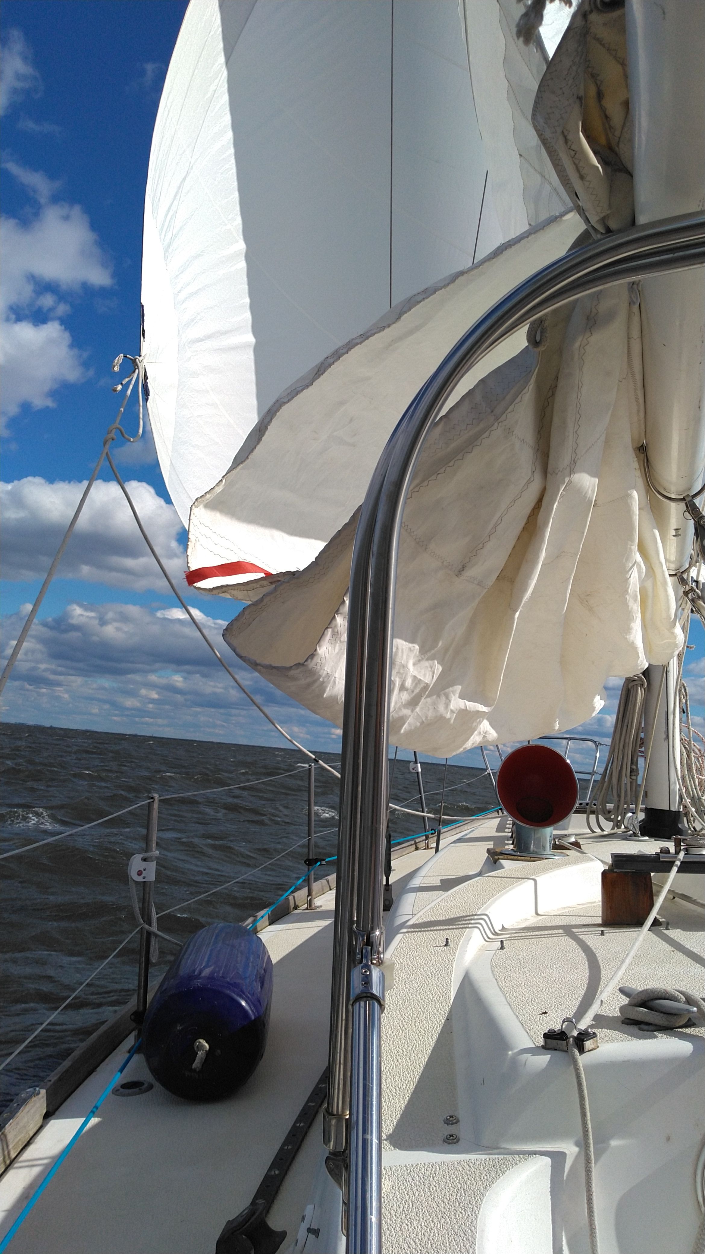 1978 Tartan 37 sailboat on open sea under sunny skies.