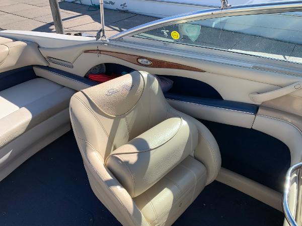 Interior of a 2000 Sea Ray 210 Bow Rider boat with beige leather seats.
