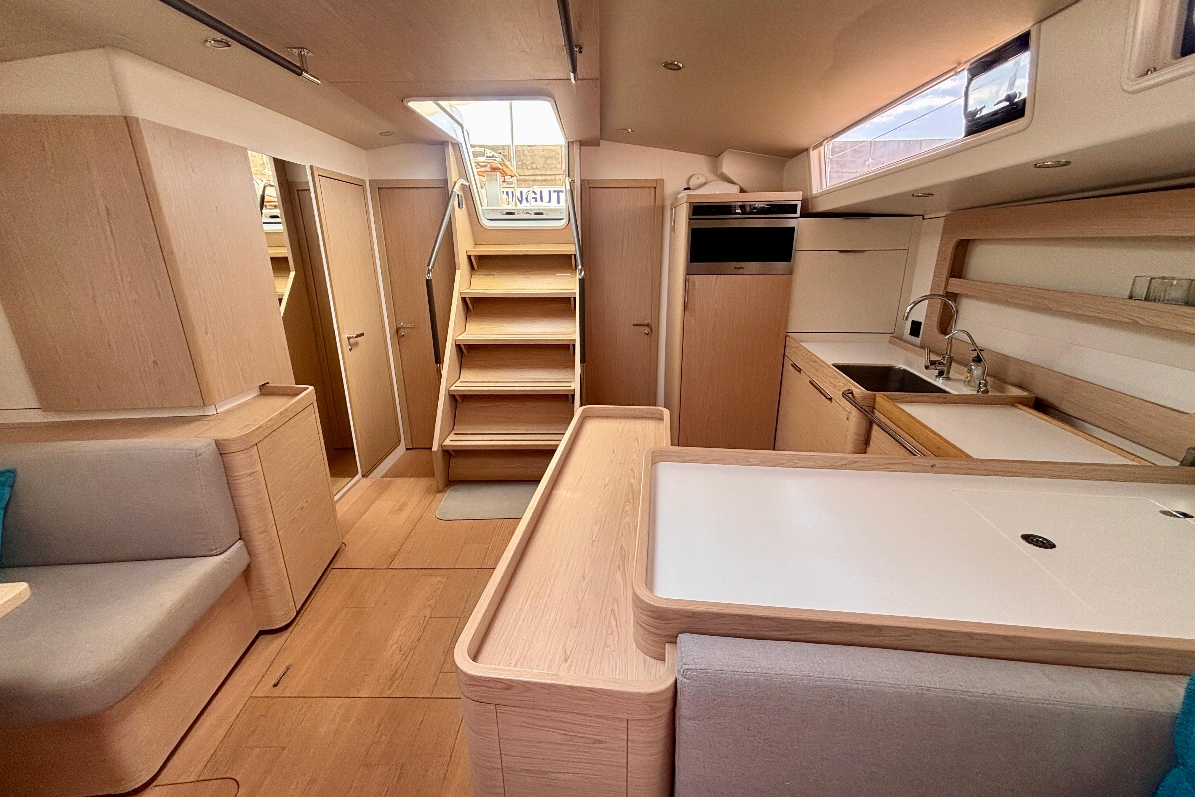 Modern interior of 2020 Beneteau Oceanis Yacht 54, featuring sleek wood finishes and spacious layout.