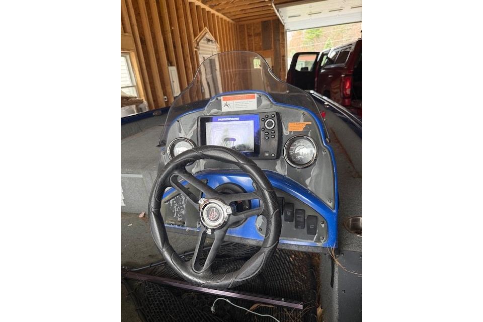 2018 Alumacraft Pro 185 boat dashboard with steering wheel and navigation controls.