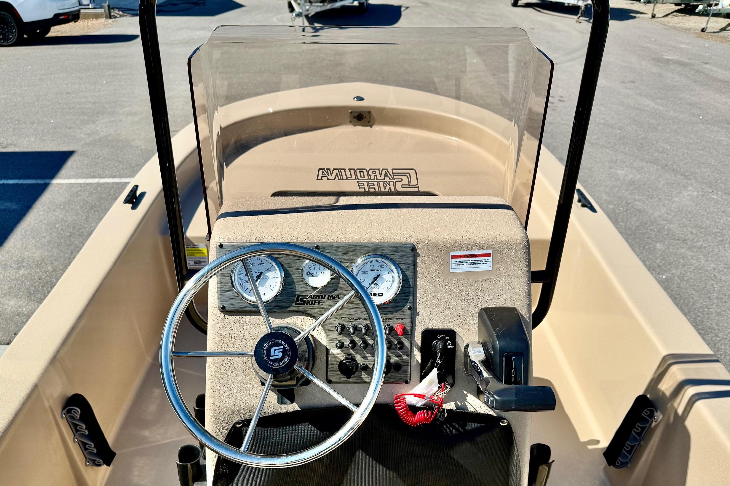 2026 Carolina Skiff E18 JVX CC boat dashboard with steering wheel and gauges.