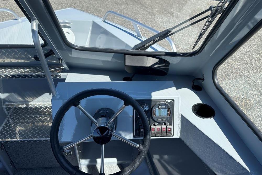 2026 Hewescraft 200 ProV ET boat dashboard with steering wheel and control panel.