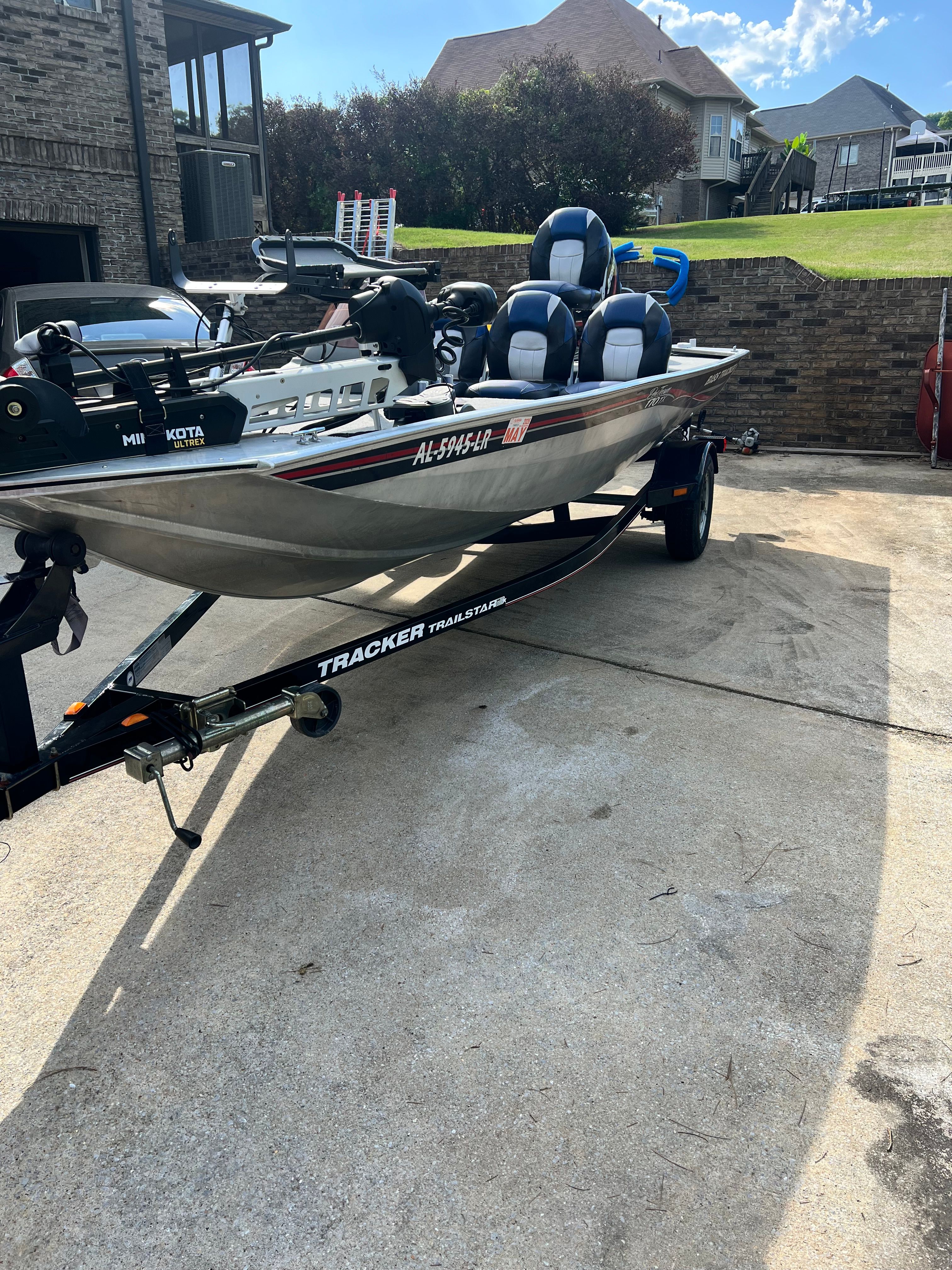 2007 Bass Tracker Pro 170 boat on trailer in driveway.