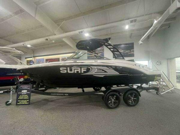 2022 Chaparral 23 Surf boat displayed indoors on a trailer.