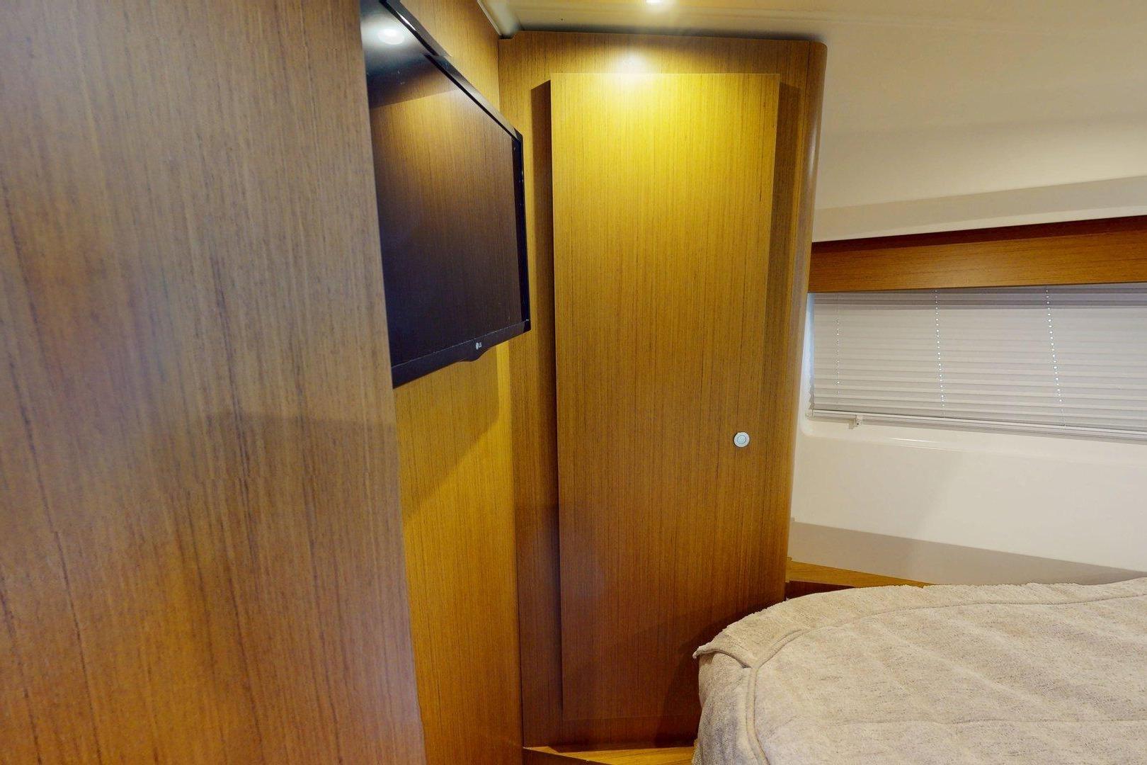 2021 Beneteau Swift Trawler 35 cabin interior with wood paneling and TV.