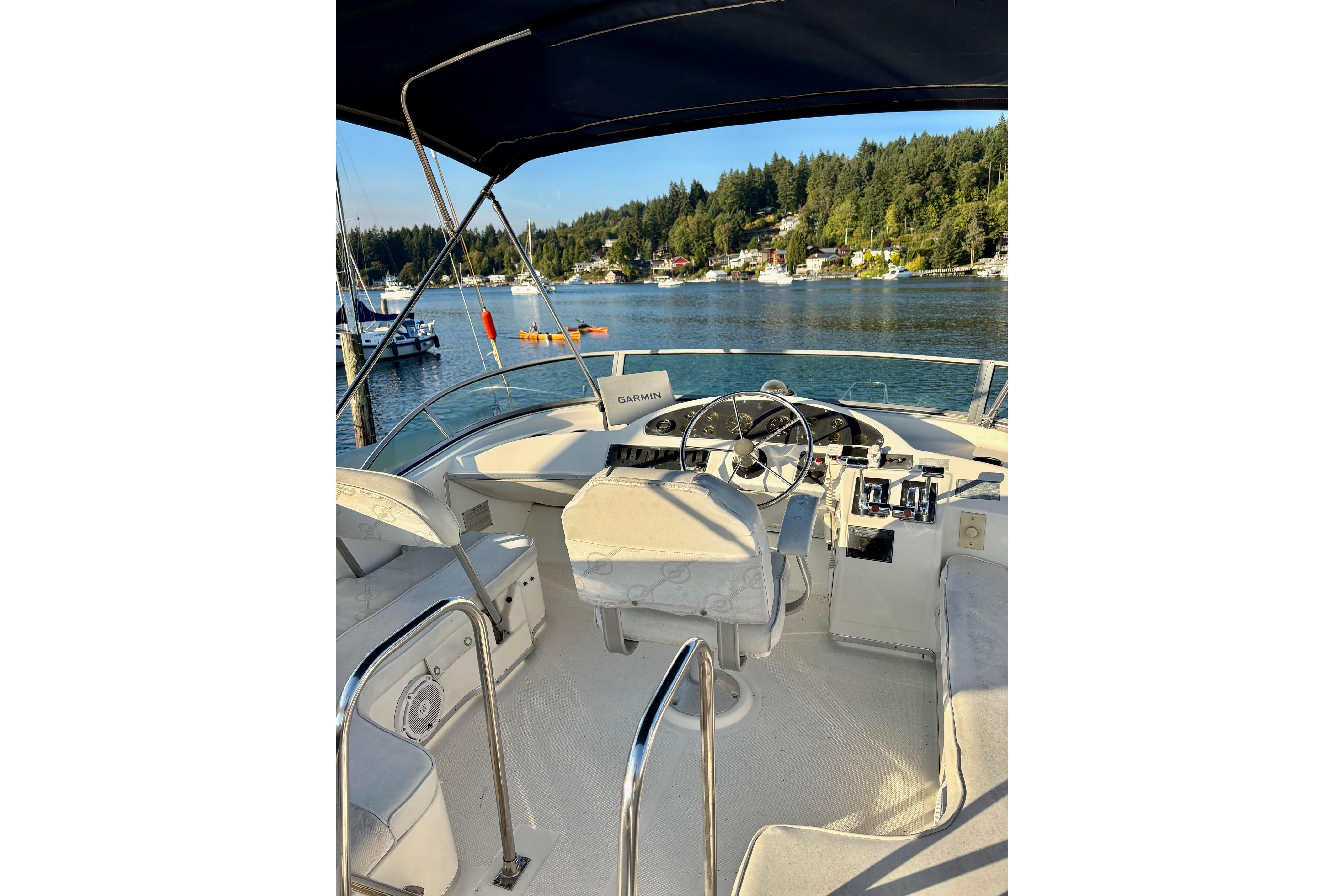 1998 Bayliner 3388 Command Bridge Motoryacht interior with scenic waterfront view.
