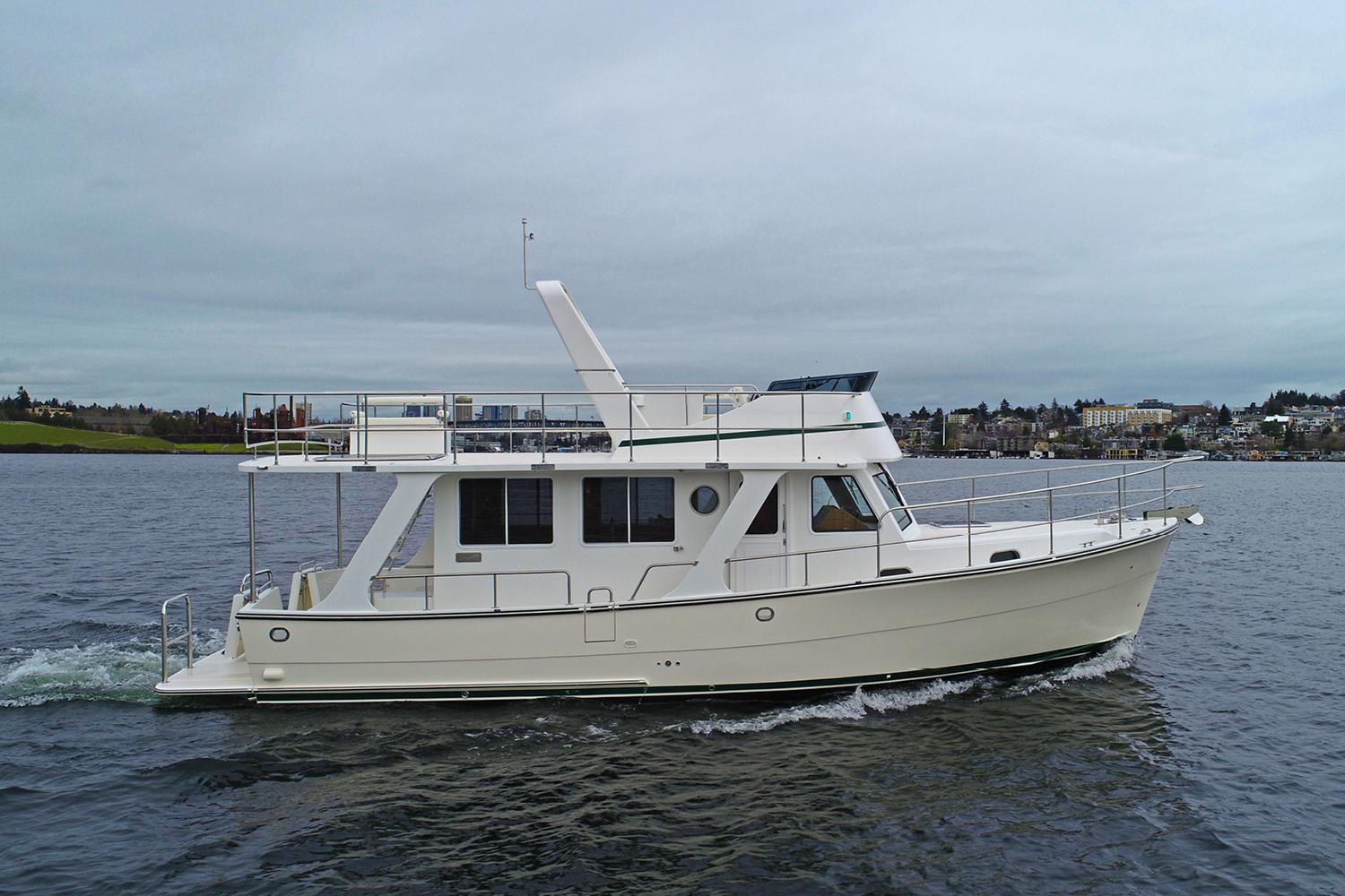 2026 Helmsman Trawlers 38 Sedan cruising on open water.