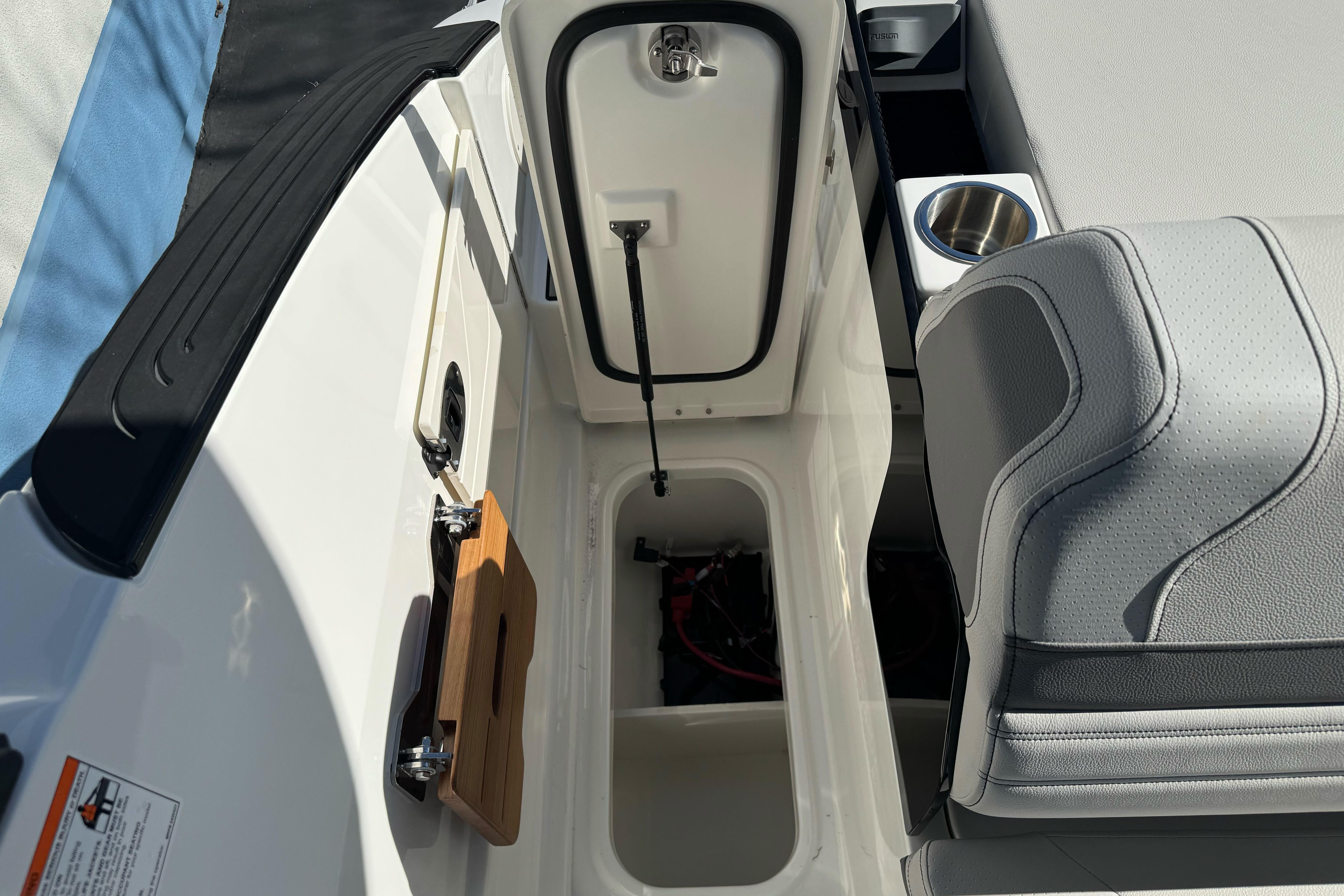 2026 Sea Ray SLX 260 boat interior with storage compartment and seating.