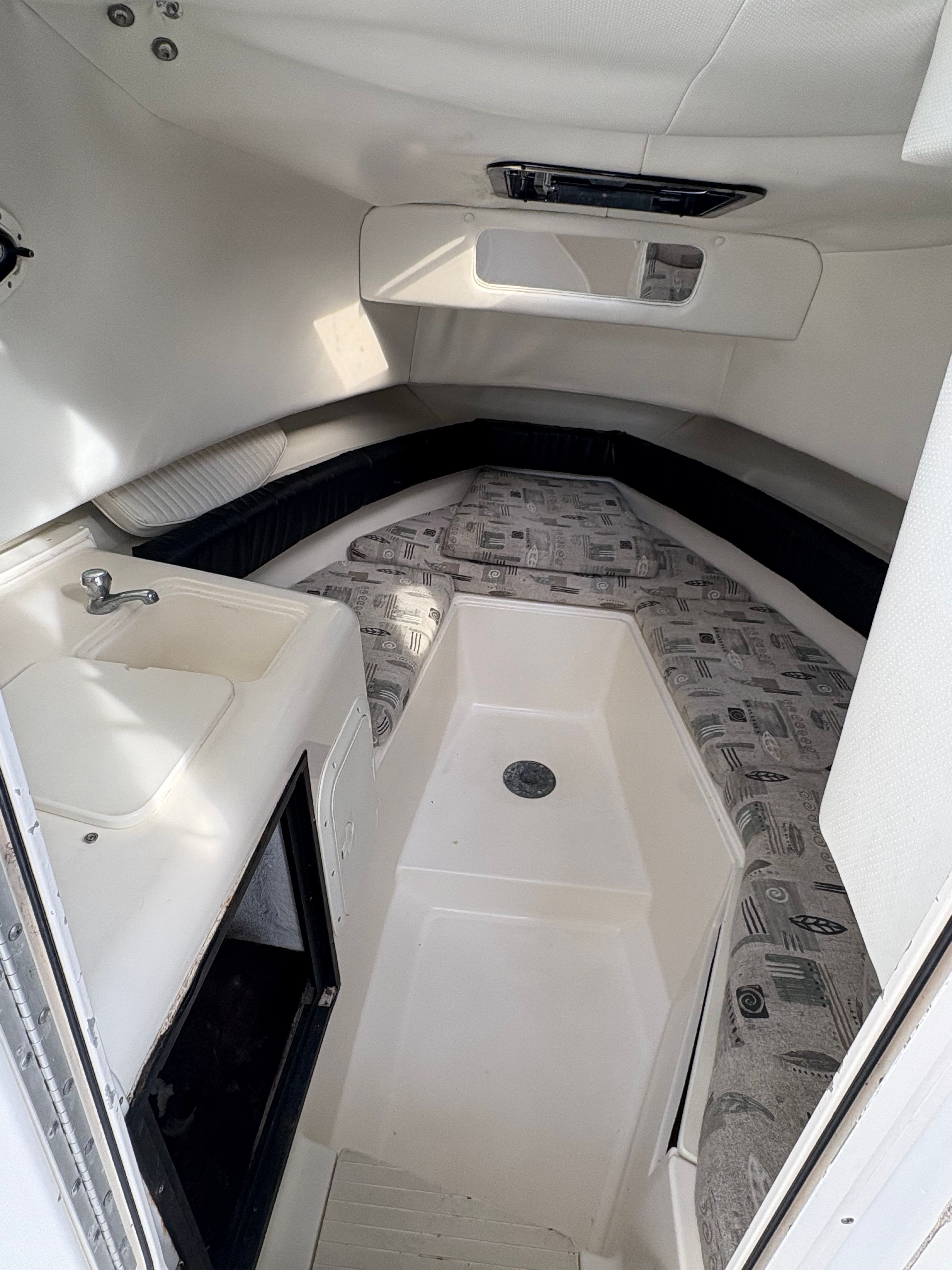 Interior of a 2000 Spacecraft Cuddy with sleeping area and sink.