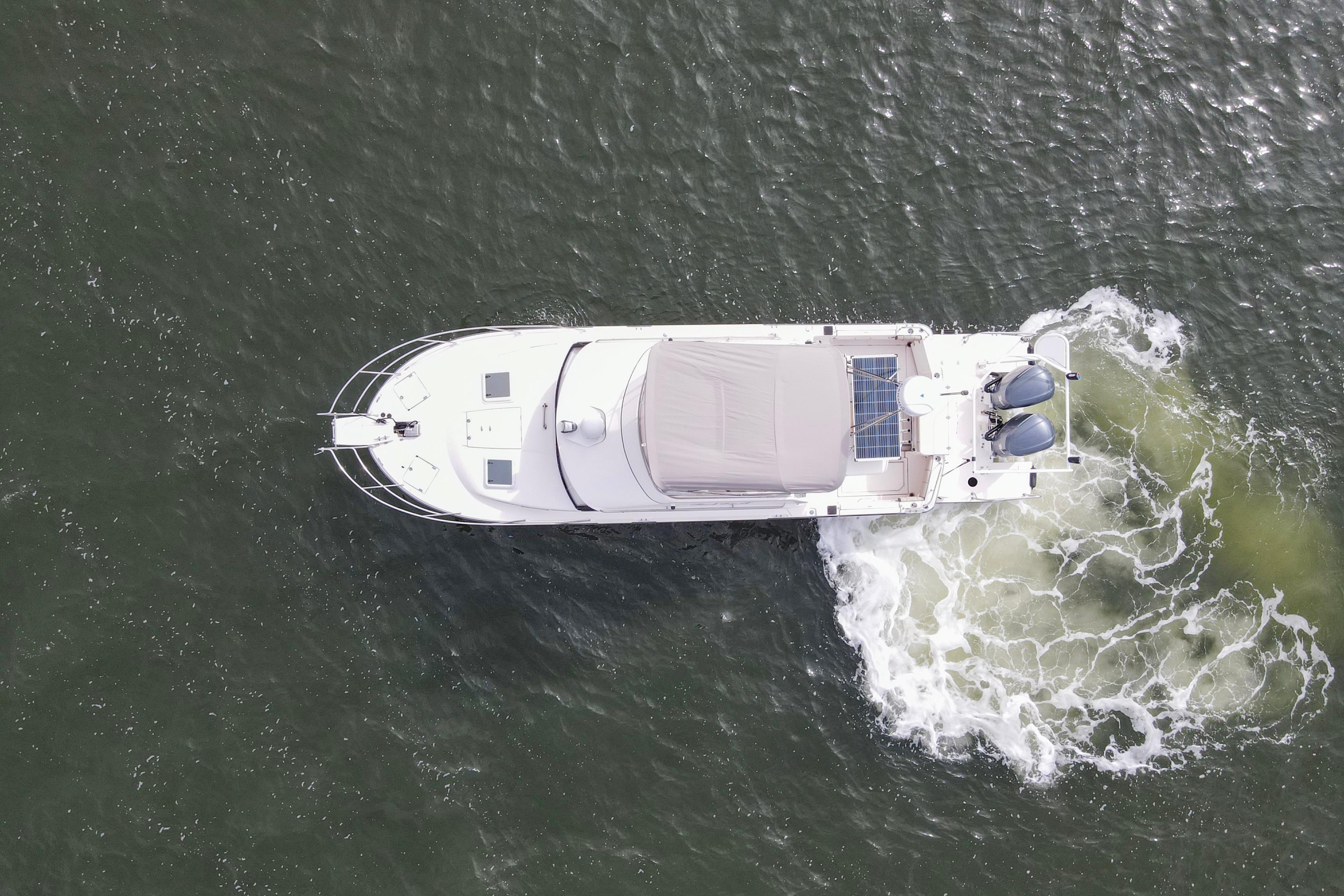 Aerial view of 2021 Cutwater C-32 CB boat cruising on water.
