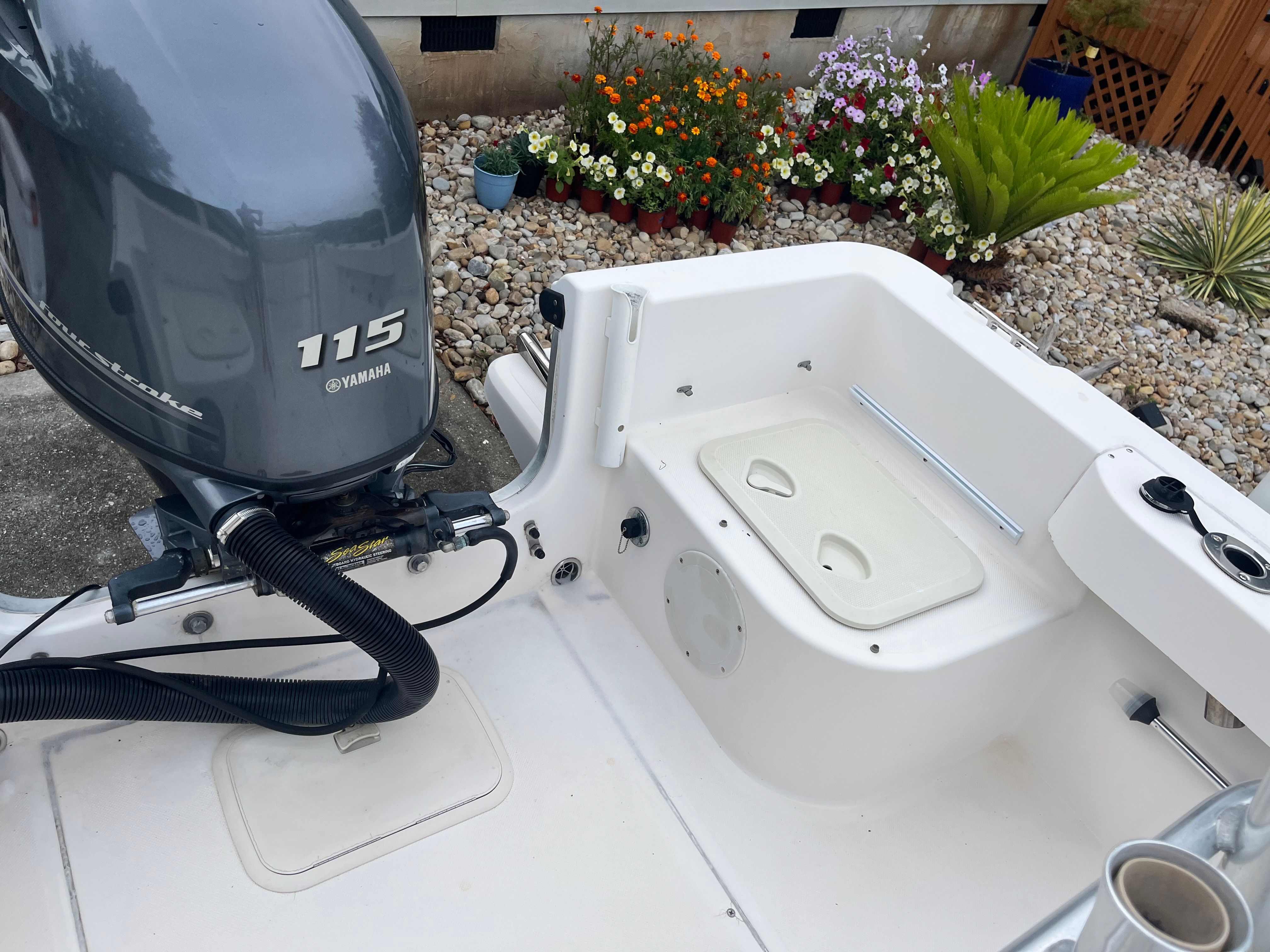 A McKee Craft Marathon 184 CC boat with a Yamaha 115 engine, parked on a paved area.
