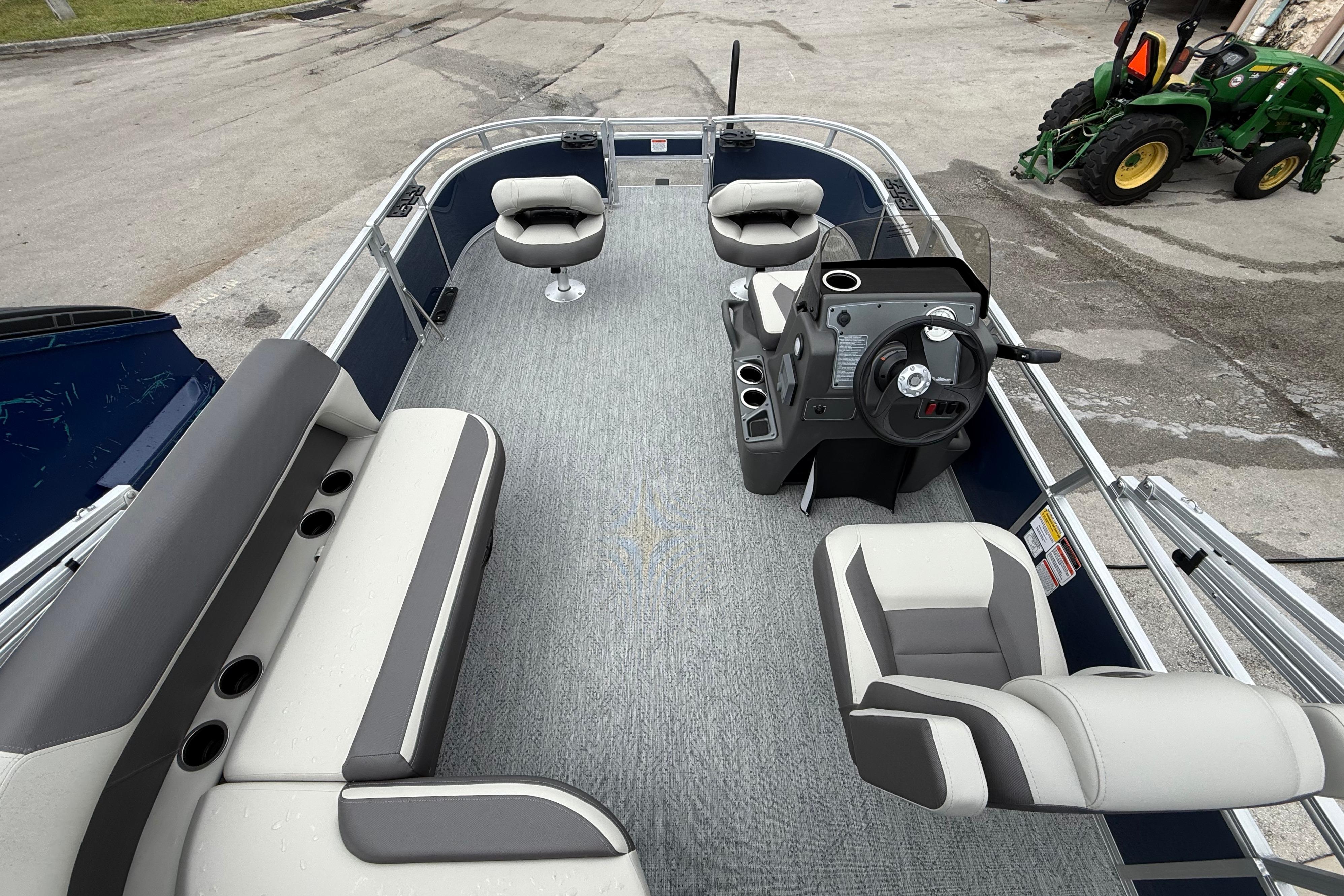 2026 Sun Tracker Bass Buggy 16 XL Select pontoon boat interior with seating and steering console.