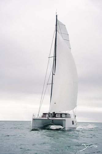 2025 Nautitech 40 Open catamaran sailing on open sea under cloudy skies.