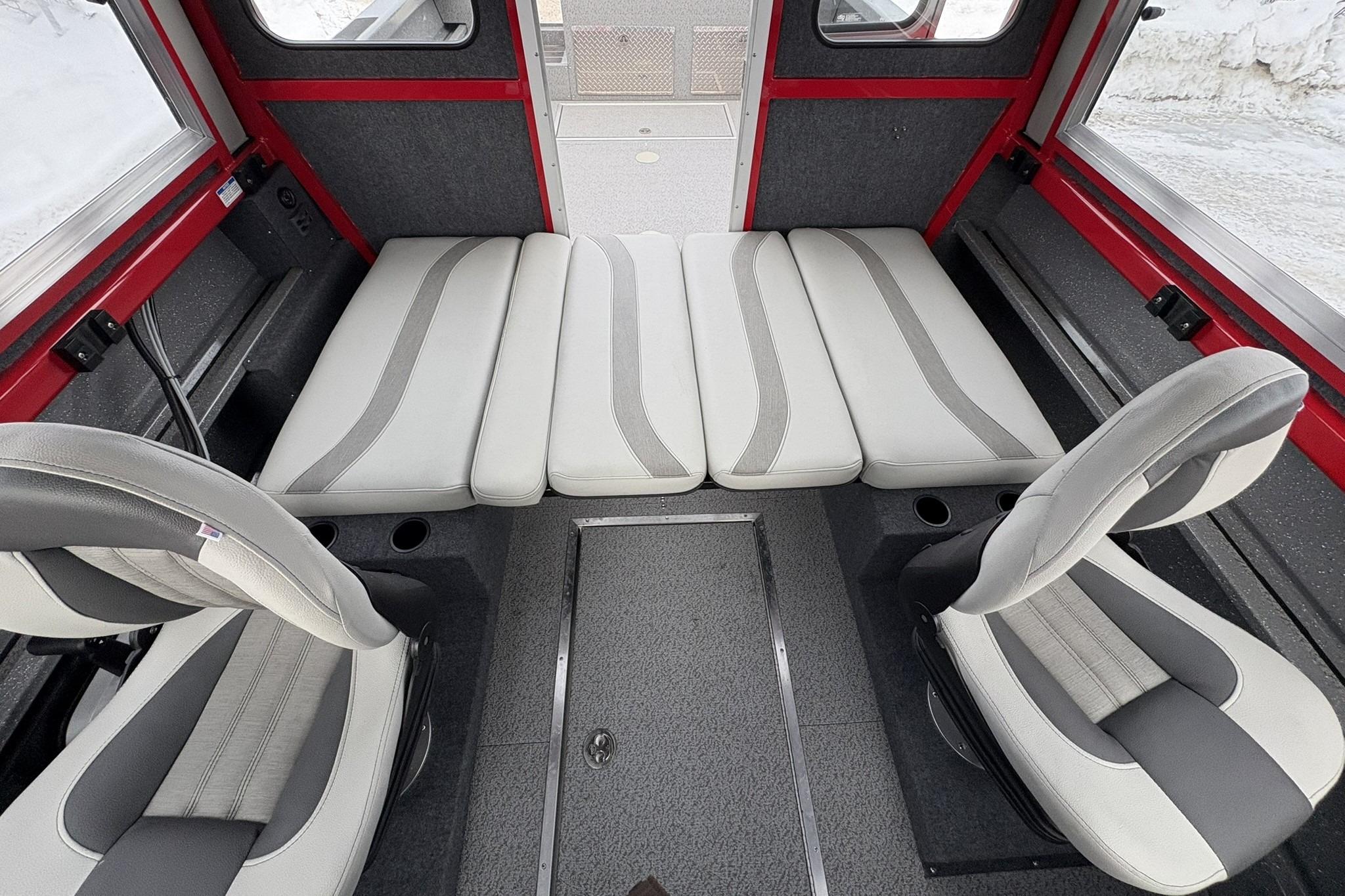 2024 Spartan 240 Maximus Pro interior with gray and white seating, red accents, and modern design.
