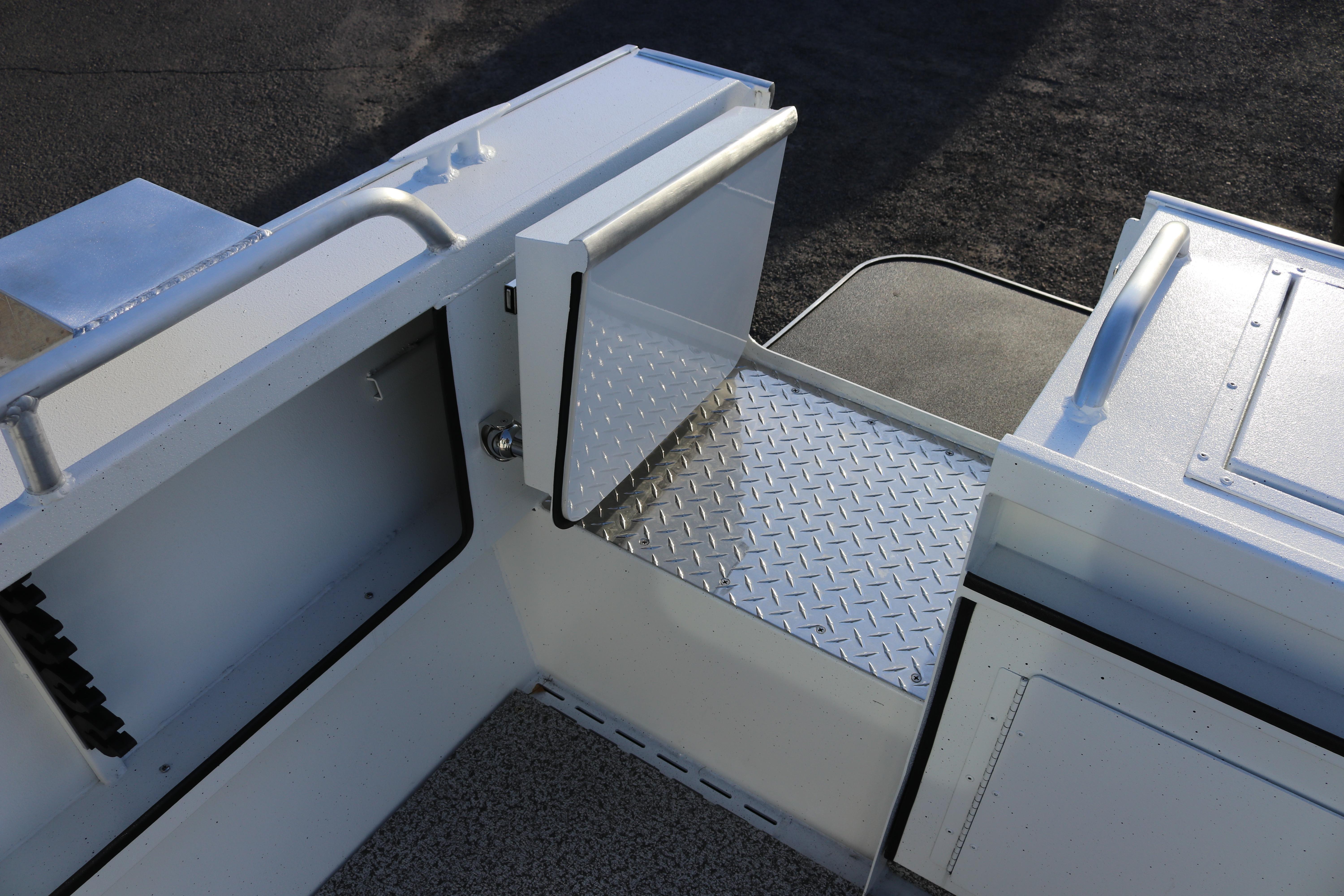 2026 Alumaweld Intruder Outboard 22 boat interior with diamond plate flooring and storage compartments.