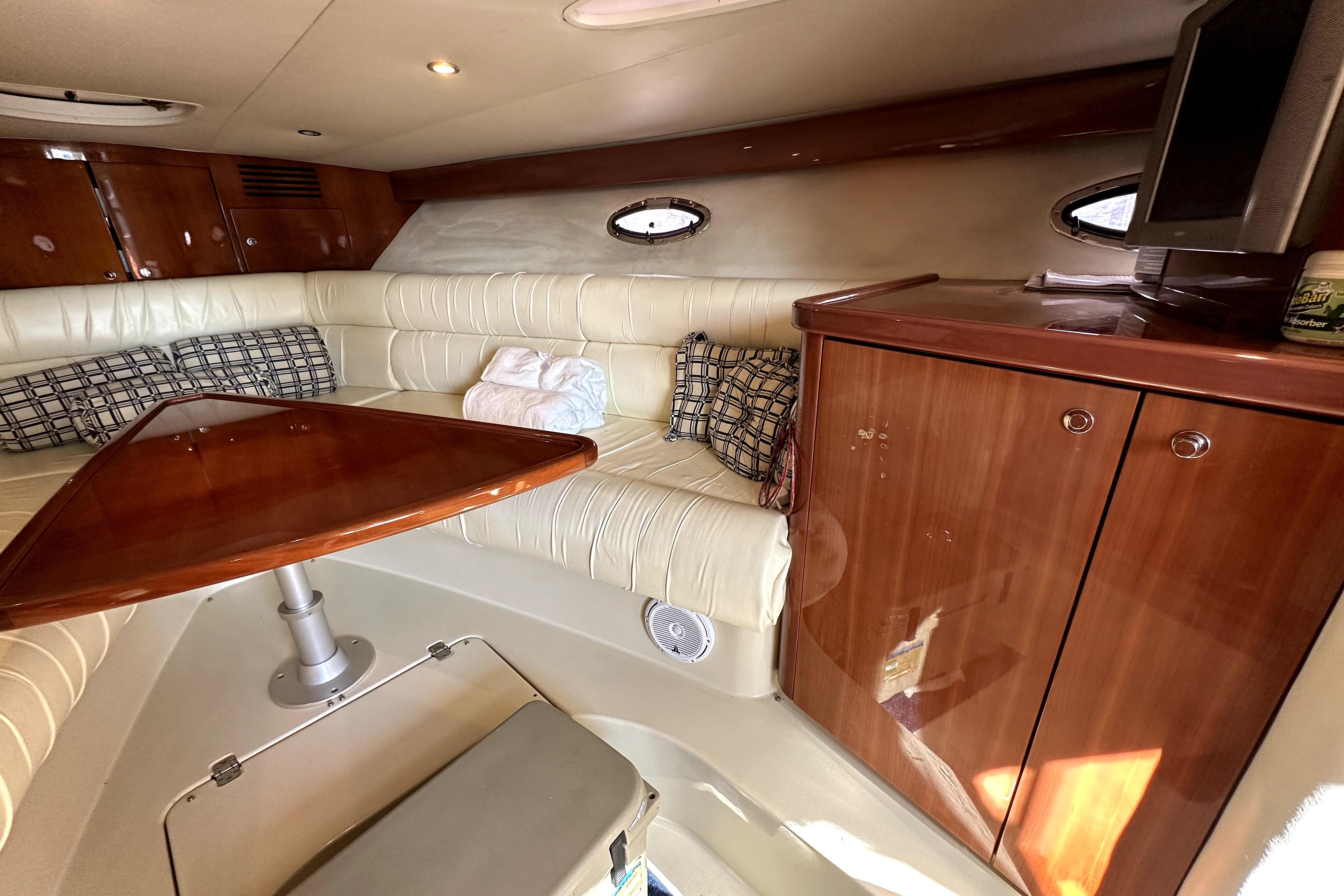 Luxurious interior of a 2003 Donzi 39 ZSC yacht with leather seating and wooden cabinetry.