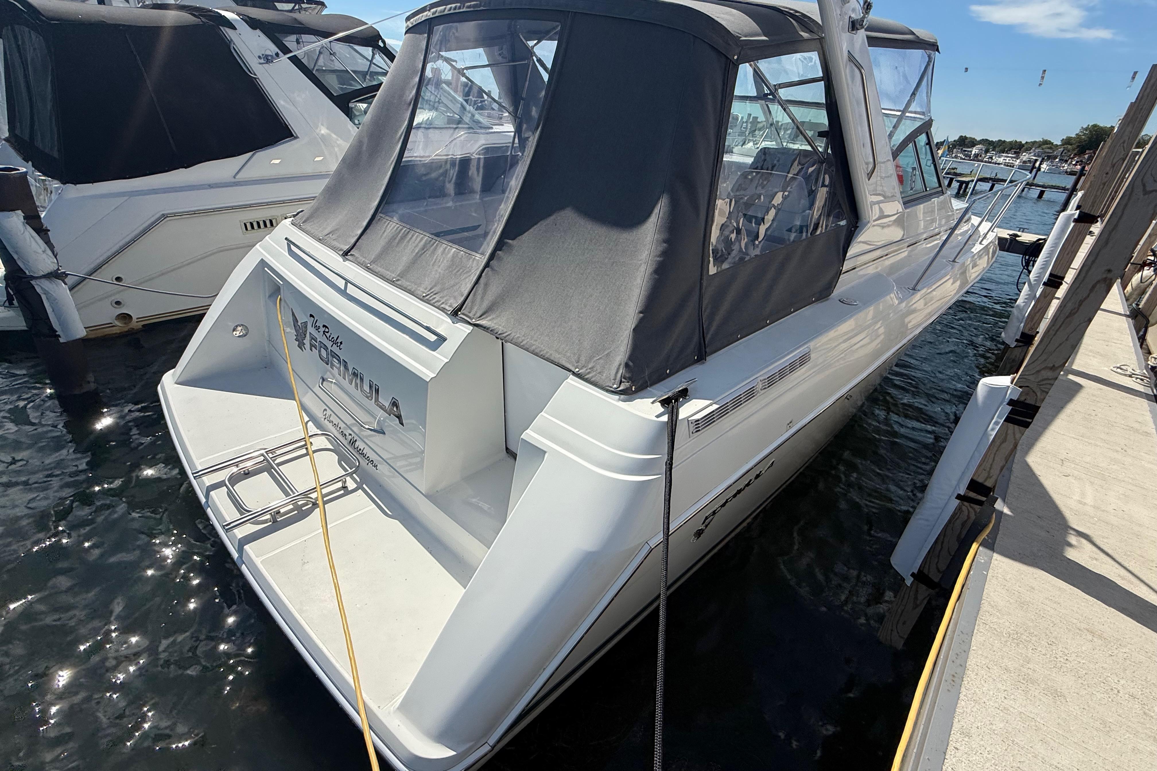 1999 Formula 34 Performance Cruiser docked at marina, rear view with canopy.