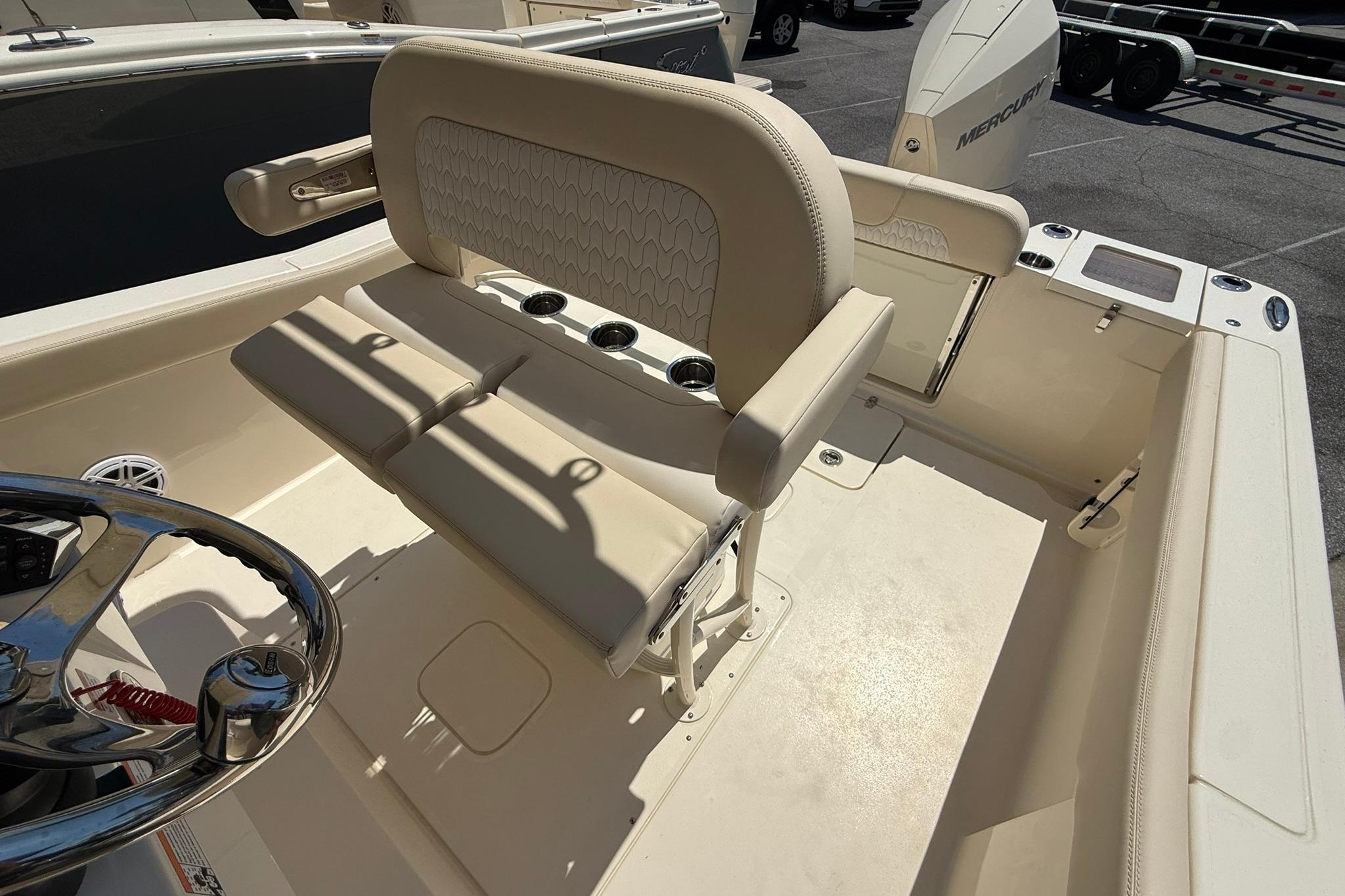 2027 Scout 240 XSF boat interior with beige seating and steering wheel.