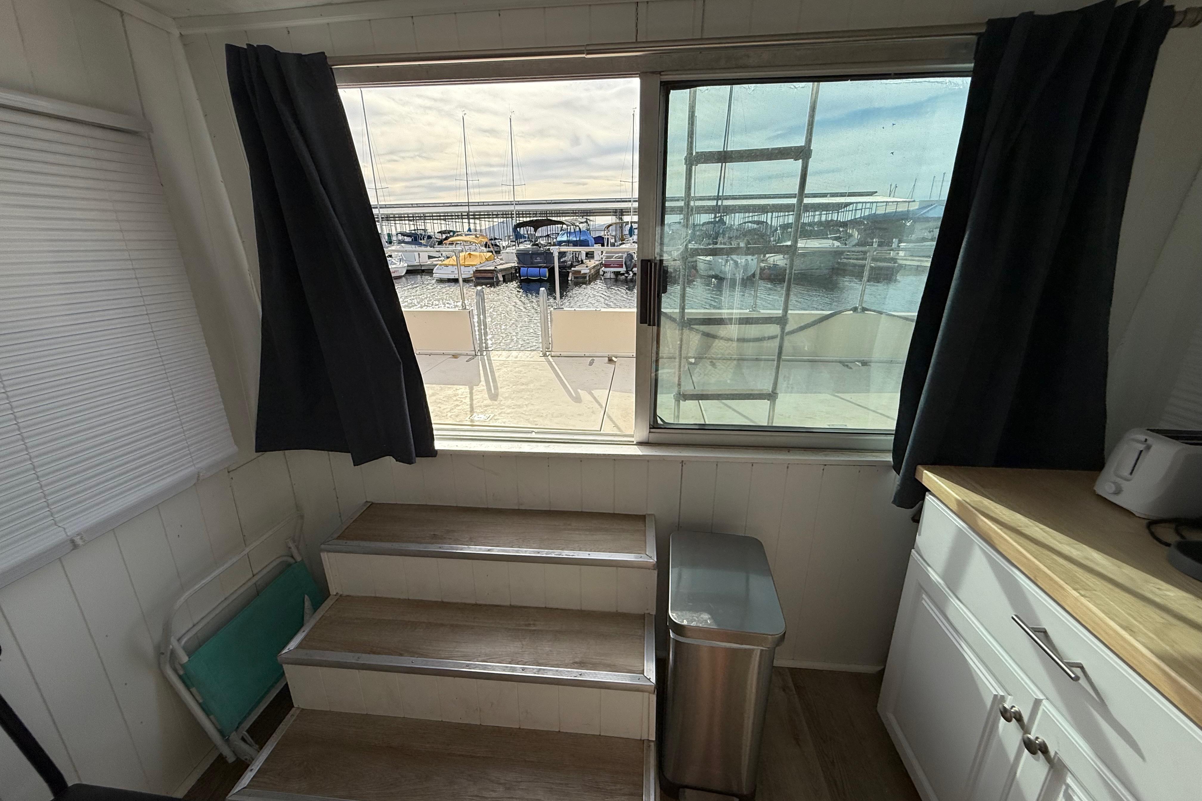 Interior view of 1983 Holiday Mansion 37 Barracuda with marina through window.