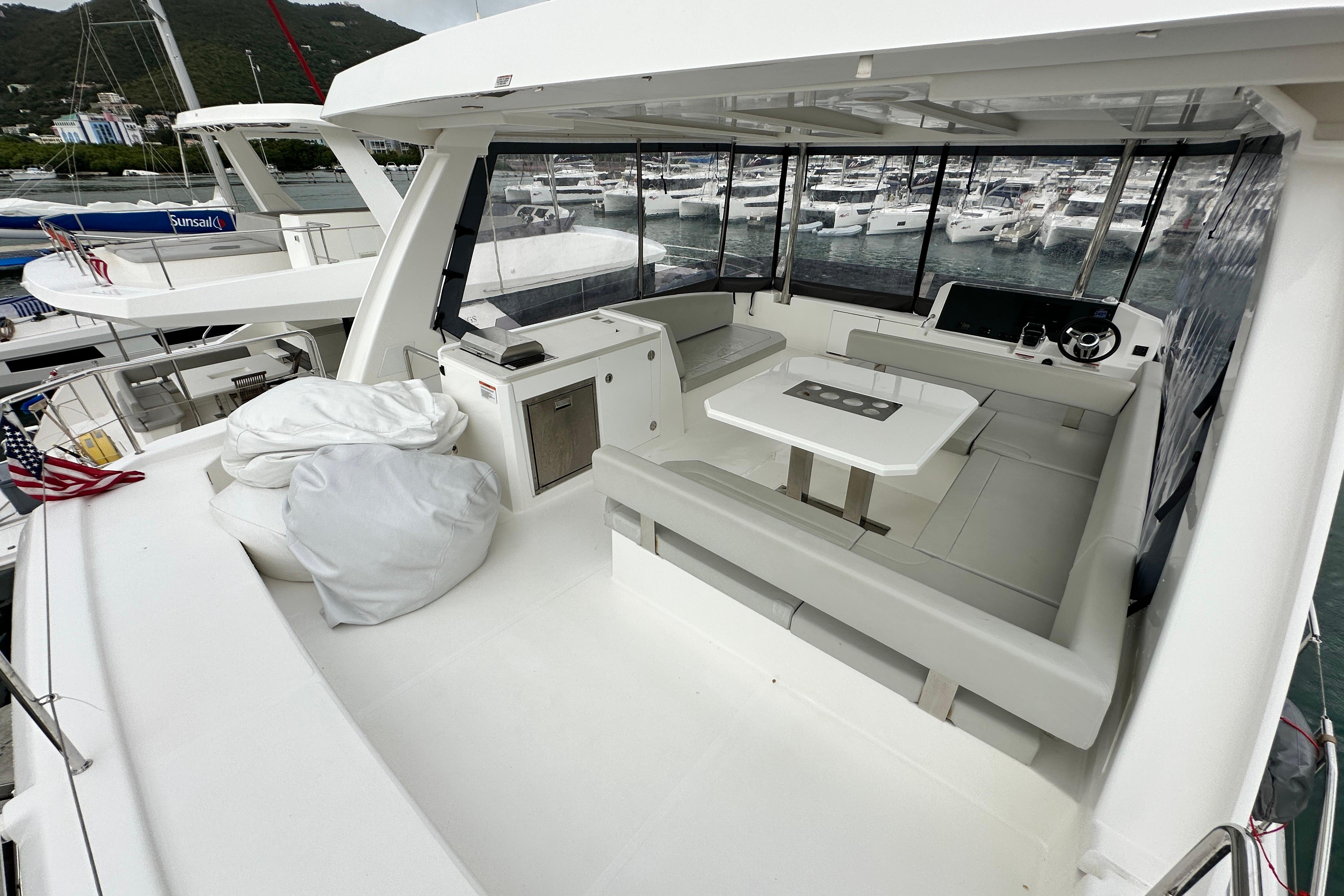 2025 Robertson and Caine Leopard 40 Powercat, spacious deck with seating and marina view.