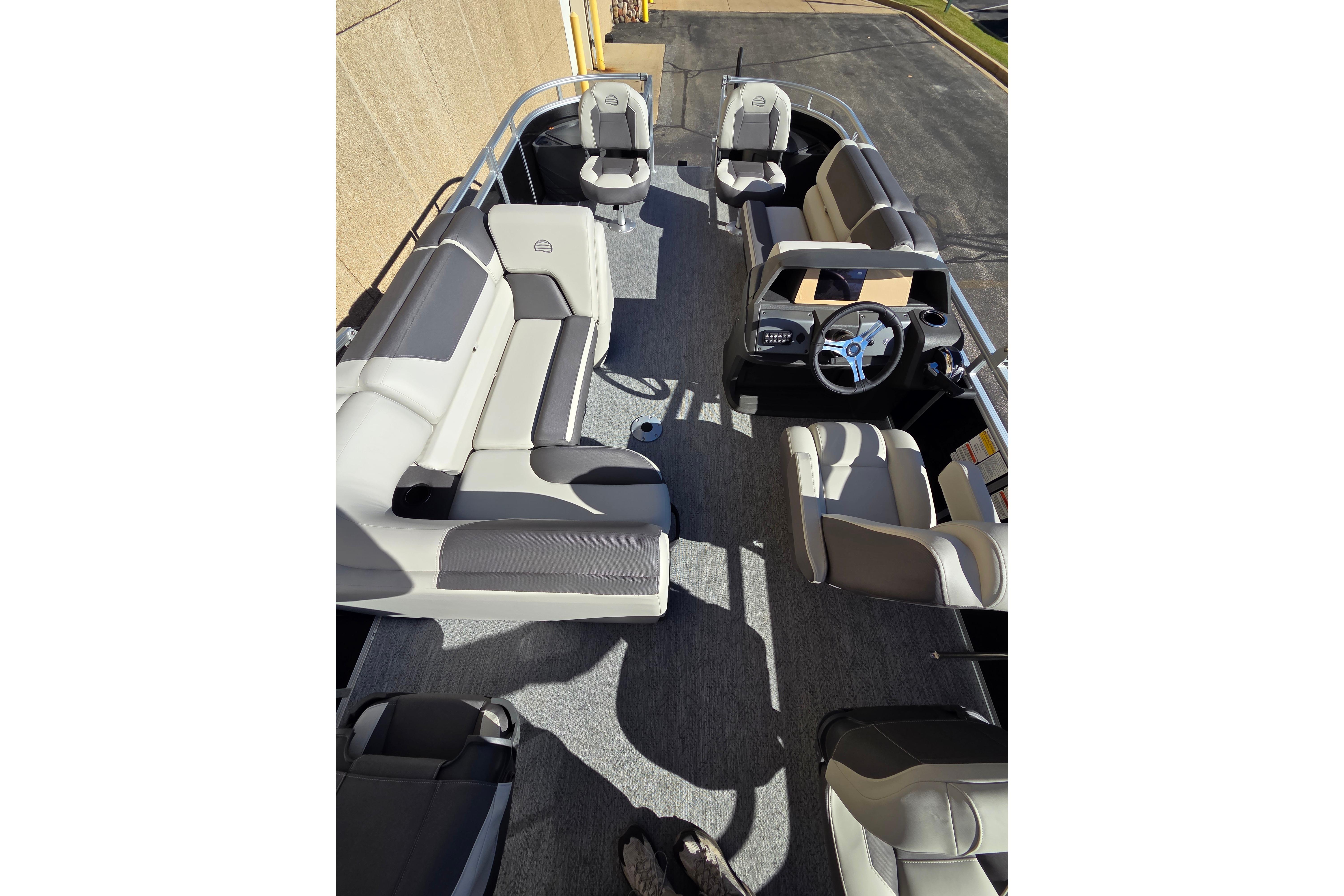 2026 Sun Tracker Fishin' Barge 20 DLX interior with seating and steering console.