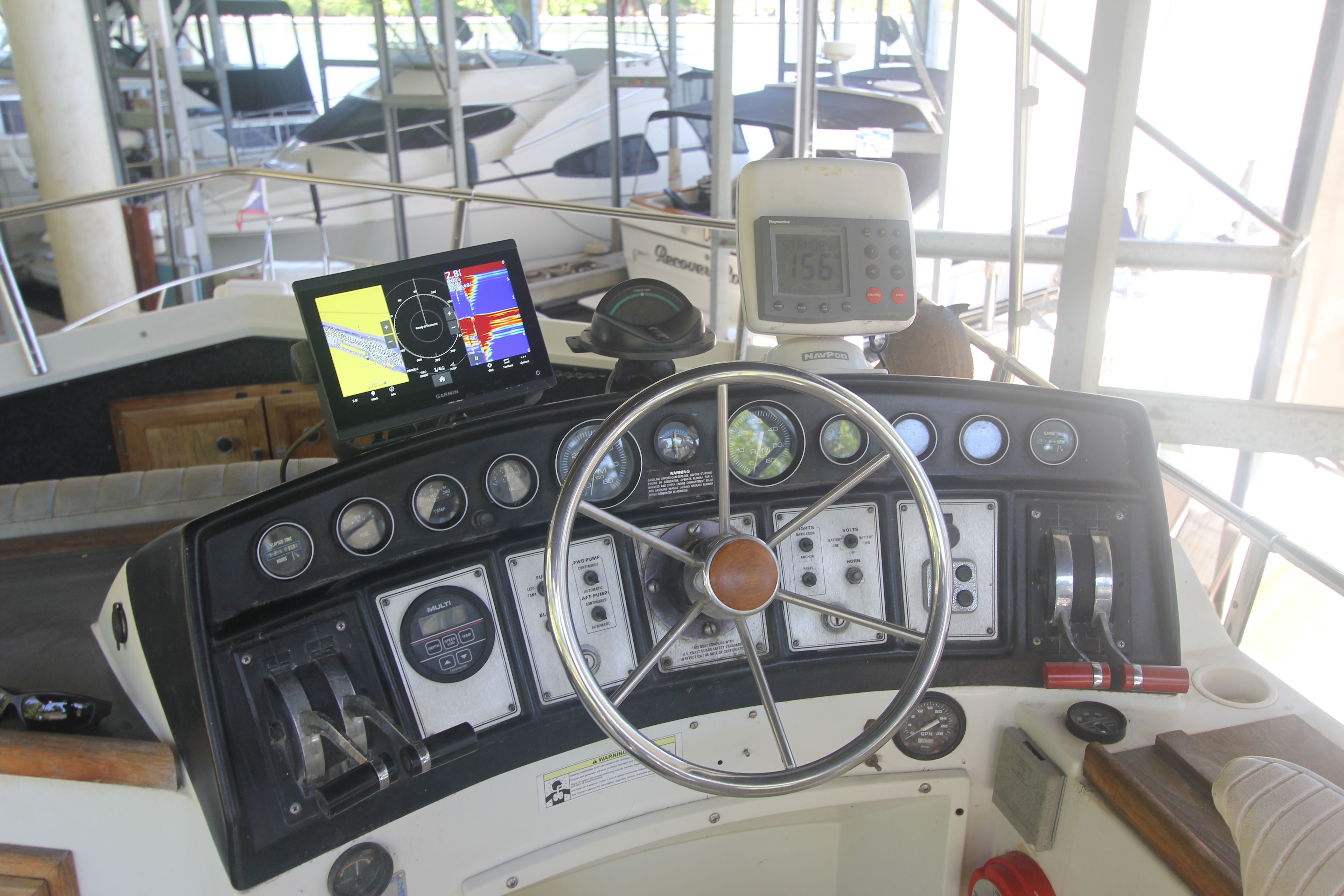 The image shows the helm of a 1988 Carver 3607 Aft Cabin Motor Yacht with navigation equipment.